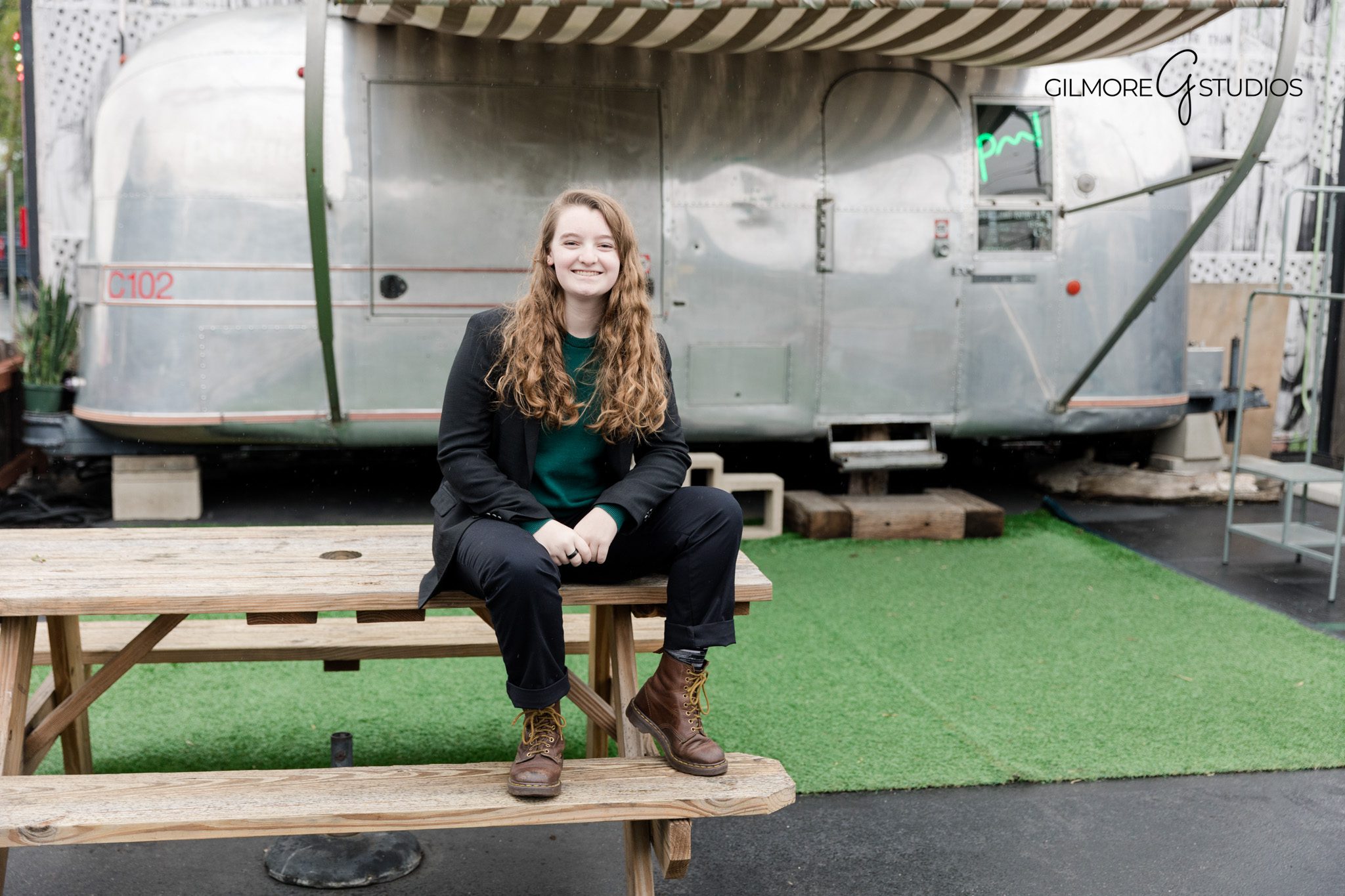 High school senior girl leaning against brick wall Gilmore Studios photography
Gilmore Studios professional senior portraits with urban chic setting
