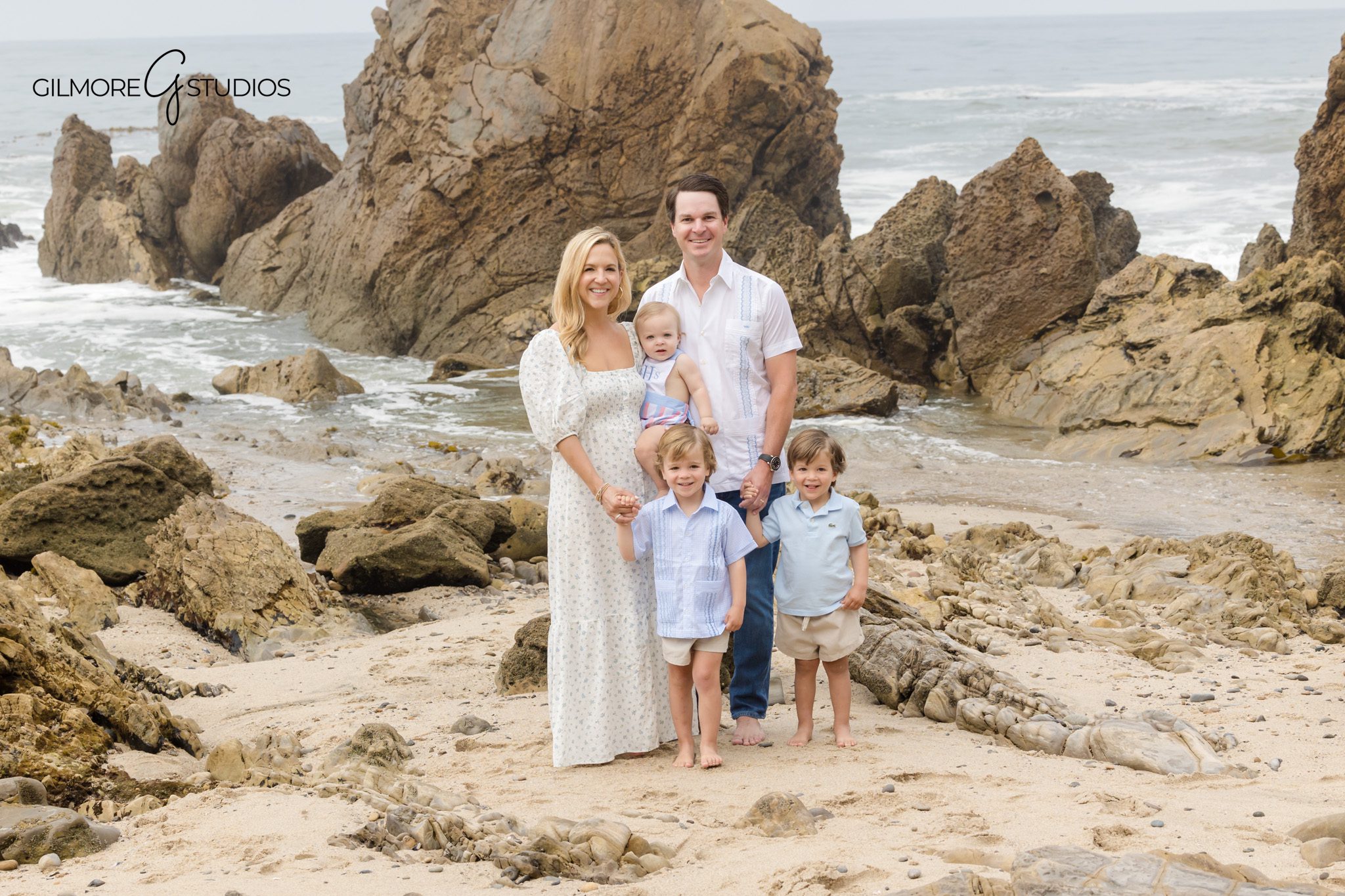 Newport Beach holiday portraits with soft pastel coastal tones.
Family photography documenting laughter during Little Corona Beach session.