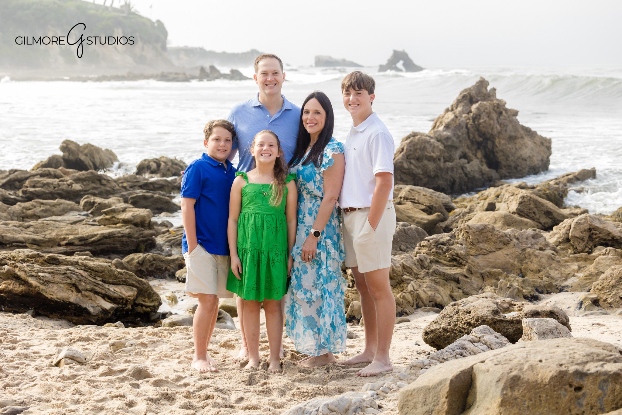 Holiday portrait photographer showing kids exploring rock formations.
Little Corona Beach family portraits with warm neutral tones.