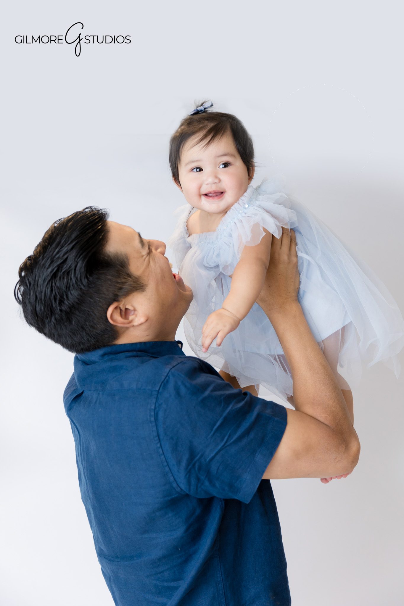 First birthday portrait photography showing baby exploring her cake.

Mermaid cake smash photographer capturing baby’s playful frosting reaction.