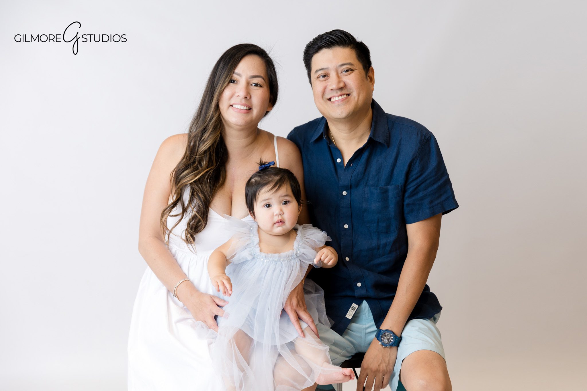Cake smash portrait photography capturing adorable frosting-covered smile.

Baby girl mermaid photoshoot with sparkly sea-inspired decorations.