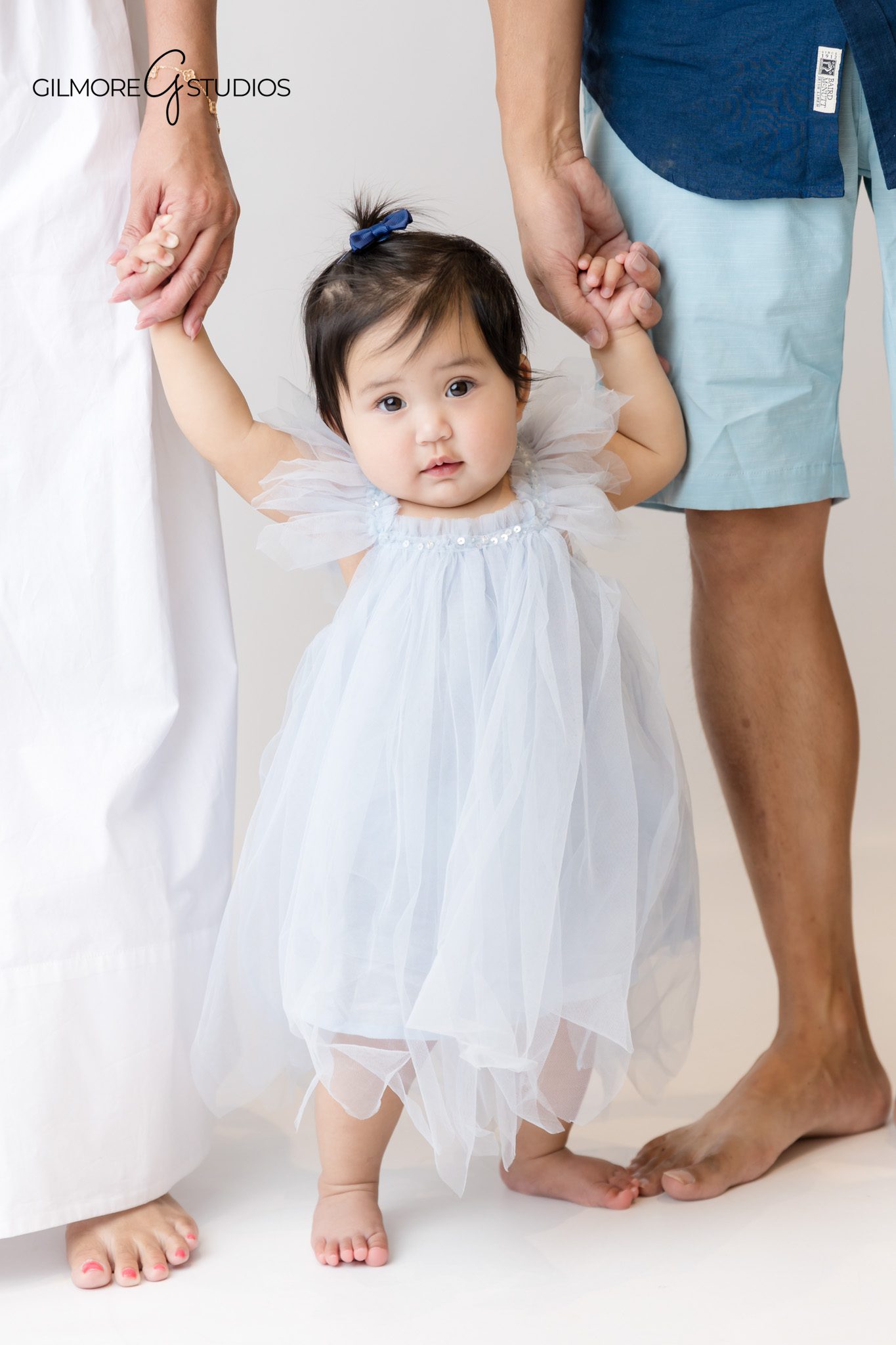 Mermaid cake smash photographer capturing baby playing with decorations.

Newport Beach studio photographer documenting baby’s first birthday milestone.