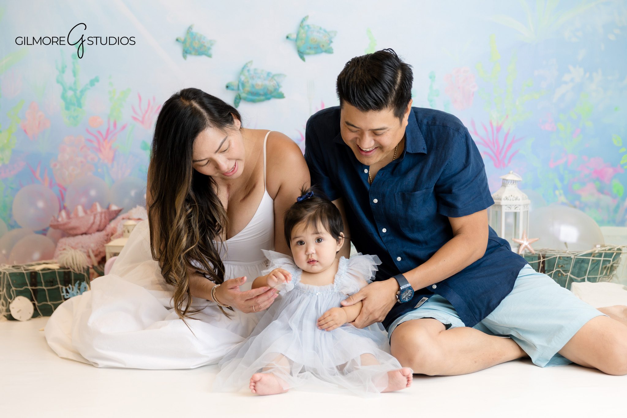 Newport Beach portrait photographer capturing sentimental first birthday session.

Baby girl cake smash photography highlighting shimmering scales and decor.