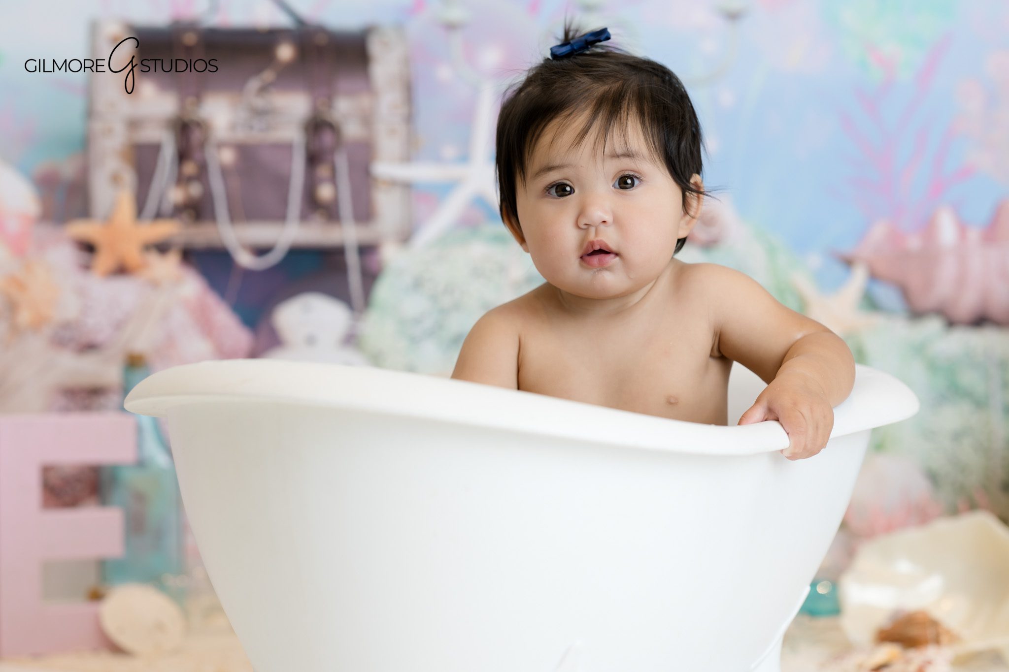 Baby girl portrait photography with teal and lavender mermaid backdrop.

Newport Beach baby photographer capturing whimsical first birthday session.