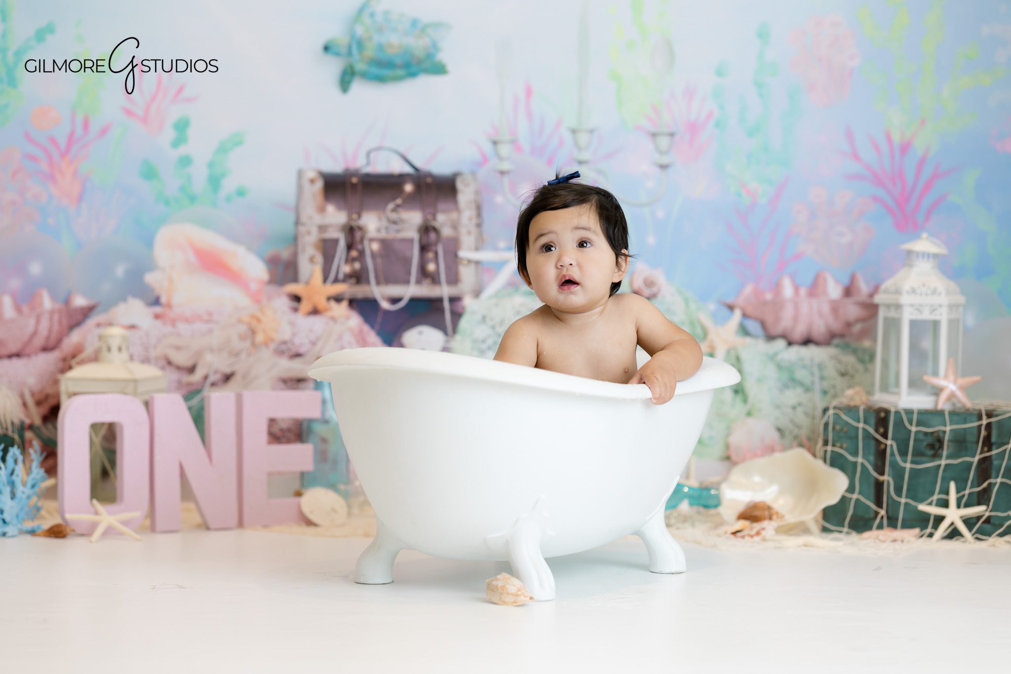 Mermaid theme first birthday photography with balloons and shells.

Newport Beach milestone photographer capturing thoughtful baby portrait.