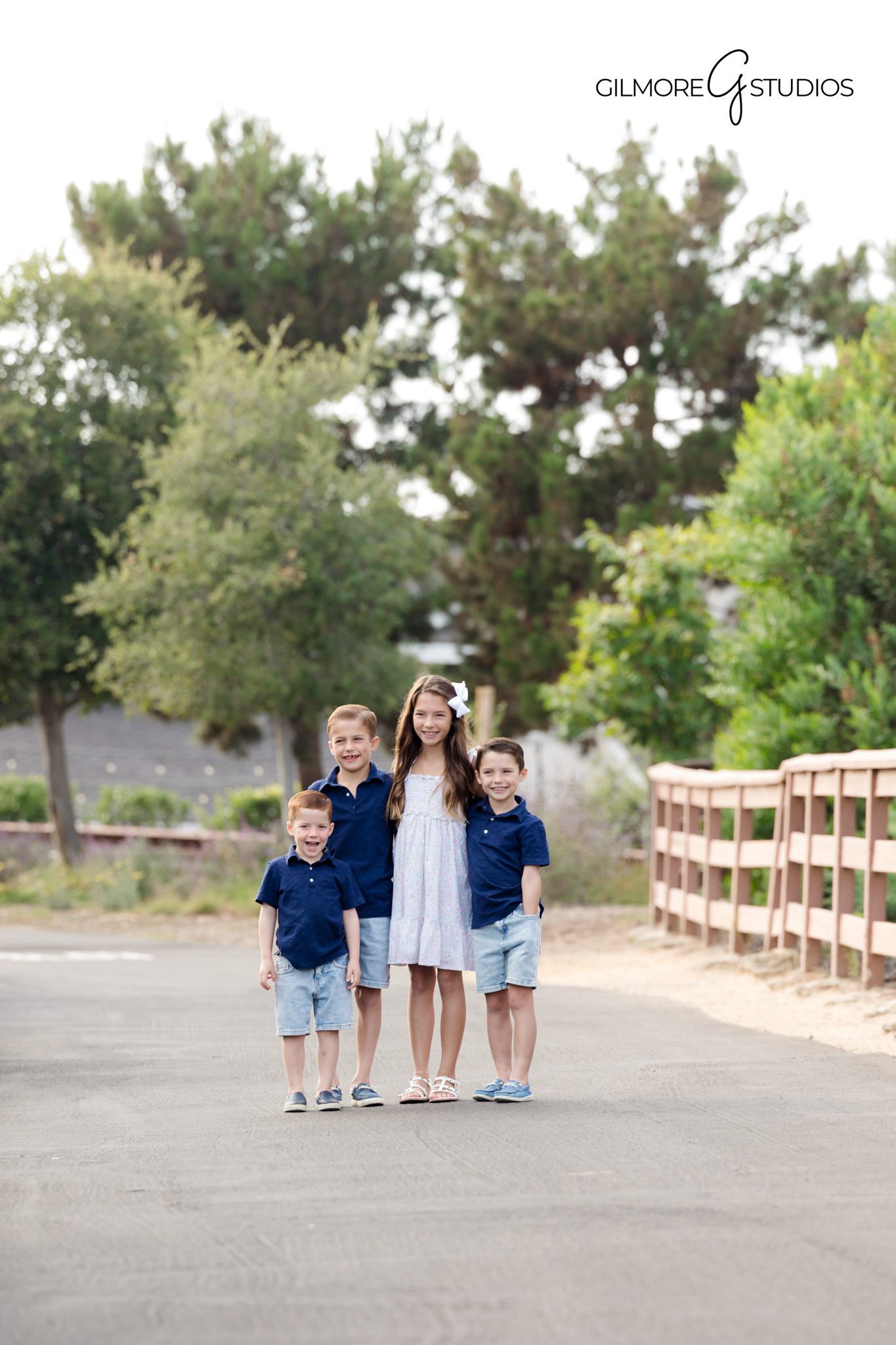 Family portrait photographer capturing parents with children at overlook.

Newport Beach photography featuring family walking along scenic path.