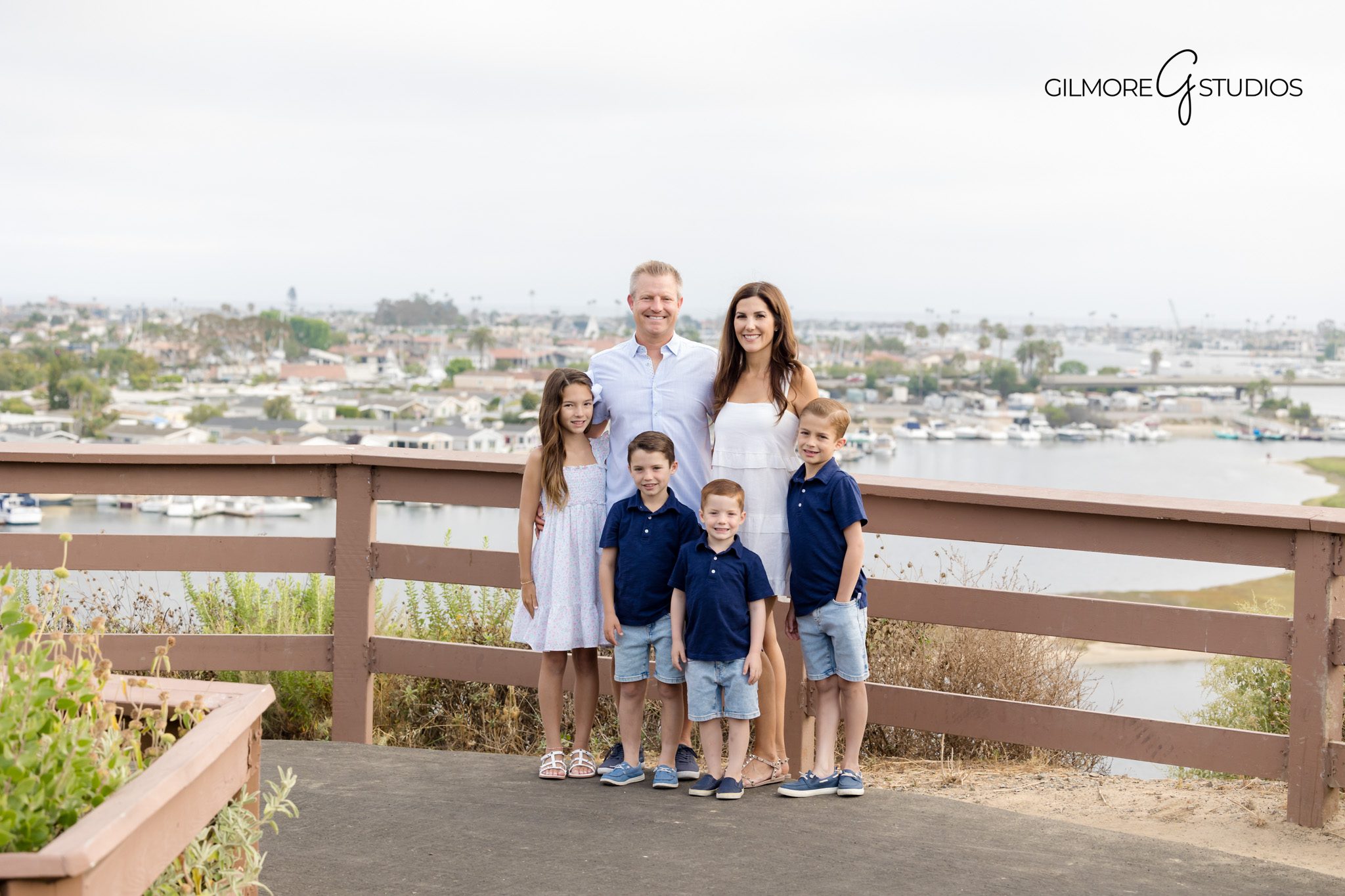 Castaways portrait photography with scenic coastal glow.

Family photographer capturing candid play at Newport bluff trail.