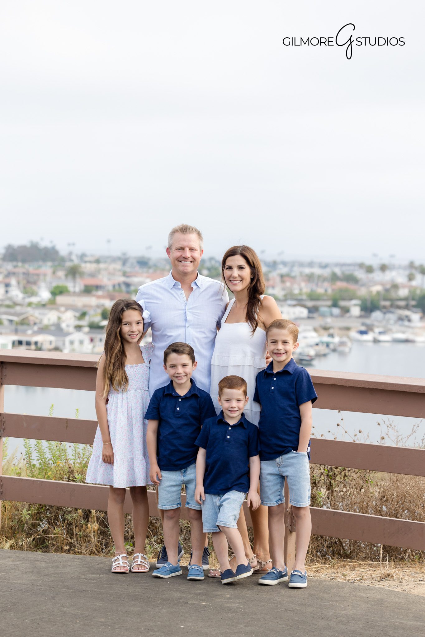 Castaways family photographer capturing candid sibling moment.

Family photography showing soft golden hour light at Newport viewpoint.