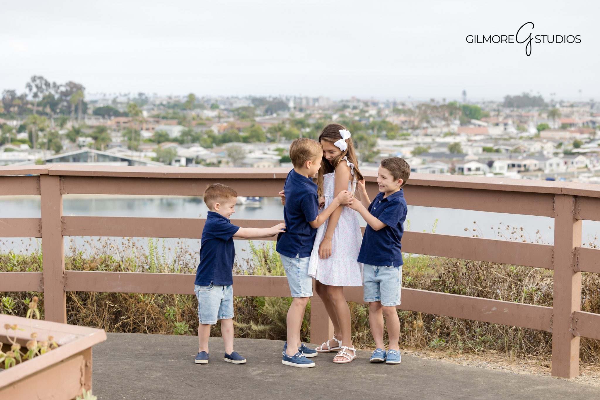 Newport Beach photographer capturing relaxed family walk through trail.

Castaways family portraits with ocean and harbor in the background.