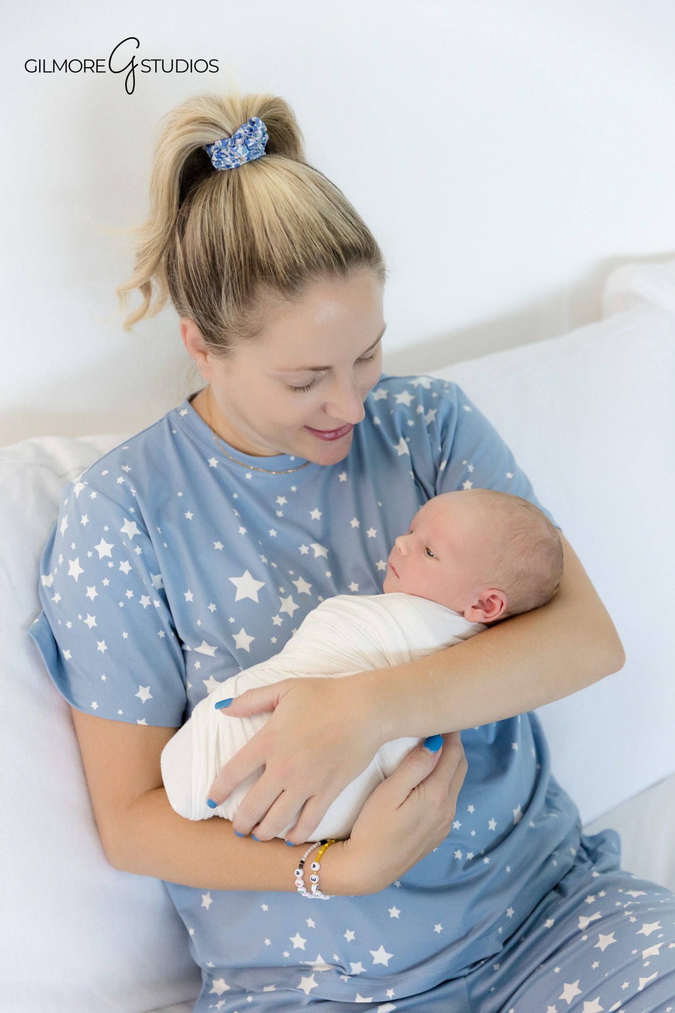 newborn photography featuring baby stretching during session,

san diego baby photographer capturing natural family interactions,