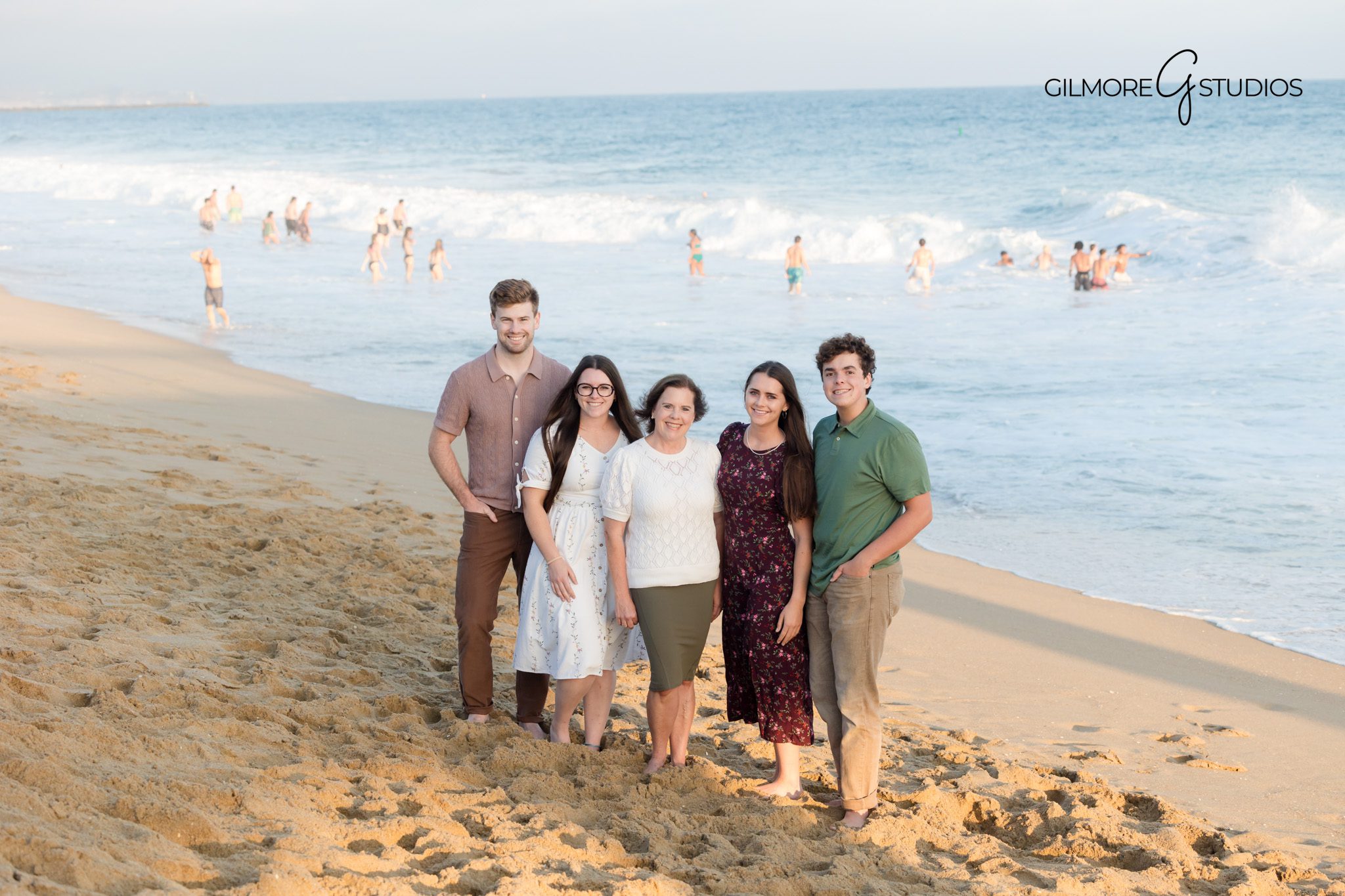 Newport Beach beach photography showing candid laughter and movement.

Family portrait photographer capturing siblings playing on the sand.