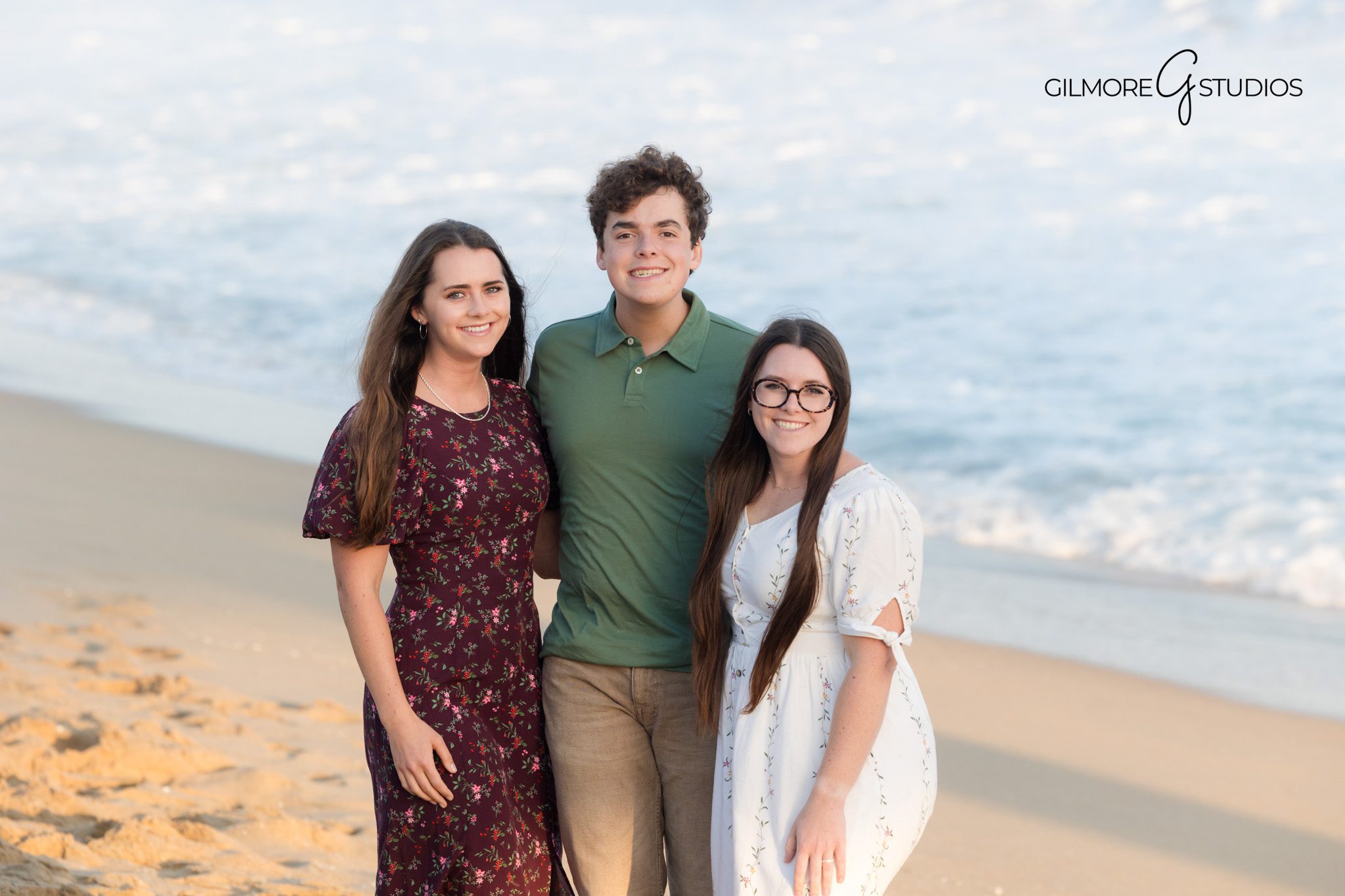 Newport Beach family session with glowing sunset backdrop.

Coastal portrait photography showing family holding hands by the pier.