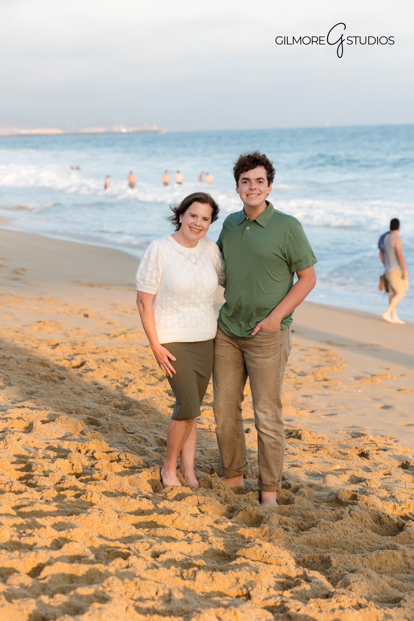 Newport Beach Pier family portrait with warm holiday tones.

Photographer capturing family cuddling during beach session.