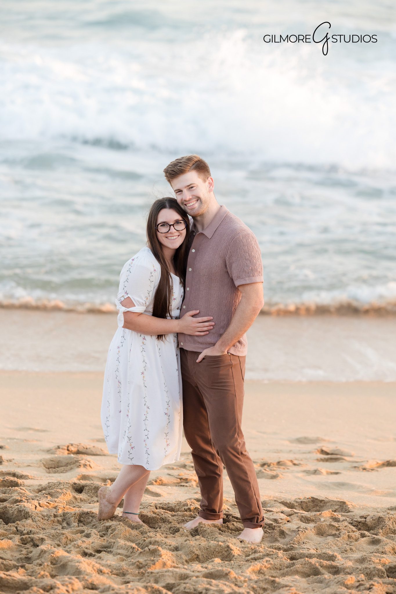 Photographer documenting parents walking with toddlers on the beach.

Newport Beach Pier portrait photography with classic family posing.