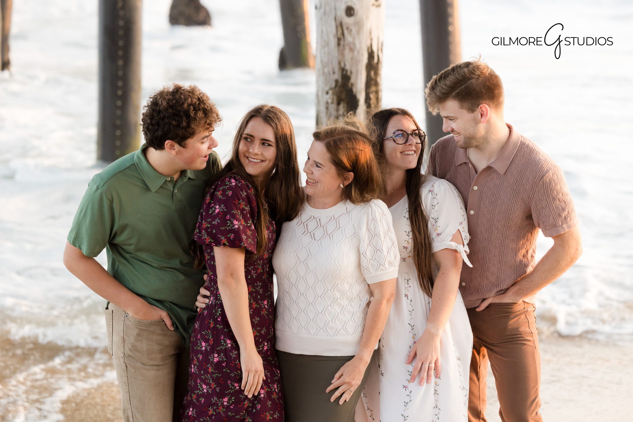 Coastal family photography highlighting iconic Newport Beach Pier.

Photographer capturing children playing at shoreline during sunset.