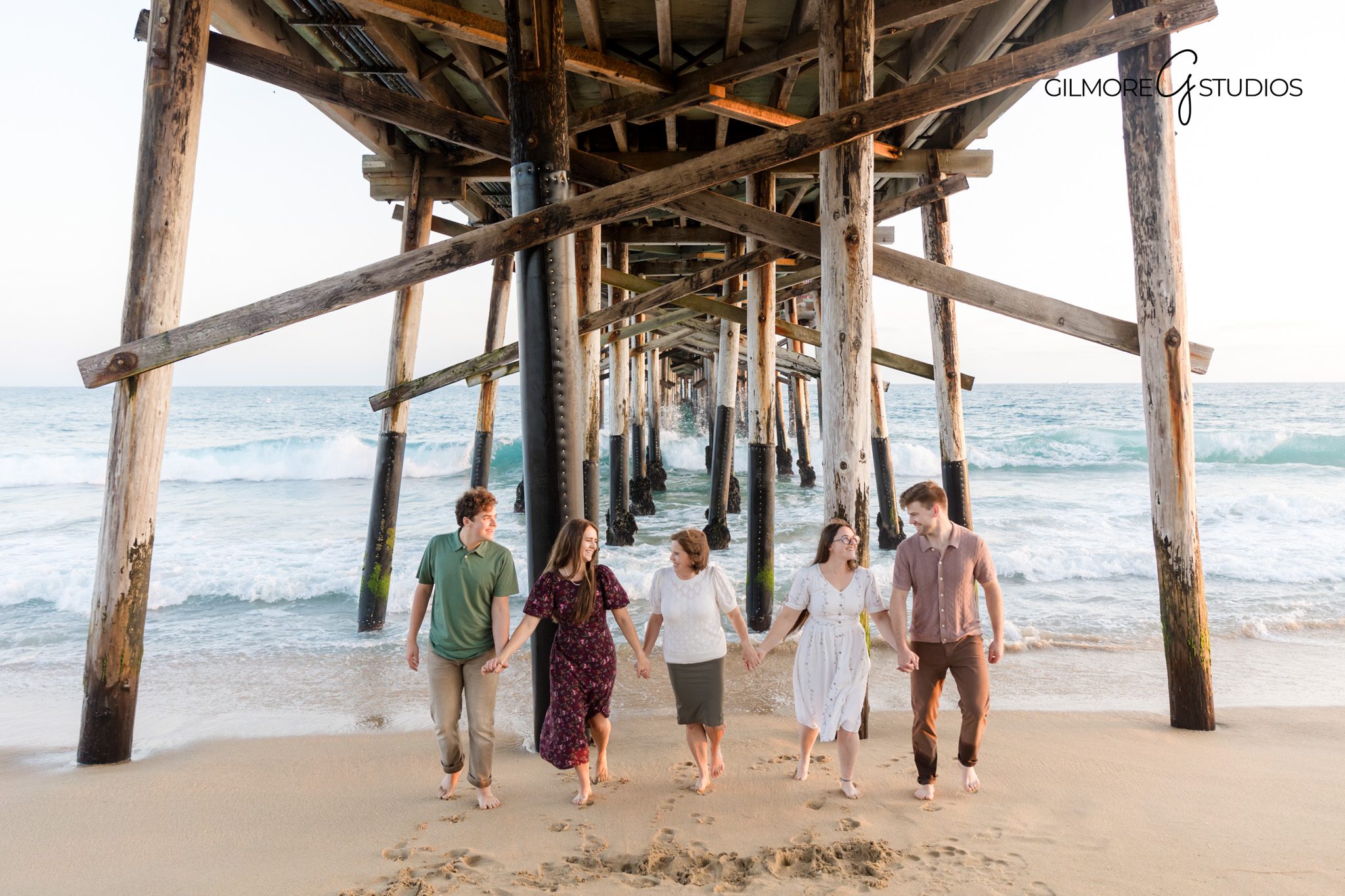 Newport Beach Pier family photographer capturing golden hour portraits on the sand.

Family photography session under Newport Beach Pier with warm sunset light.
