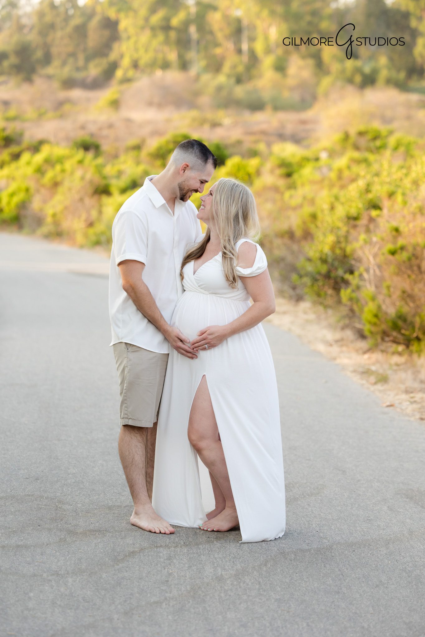 Crystal Cove maternity portrait showing expecting mother in soft neutrals,

Coastal portrait photography capturing maternity silhouette against sunset,