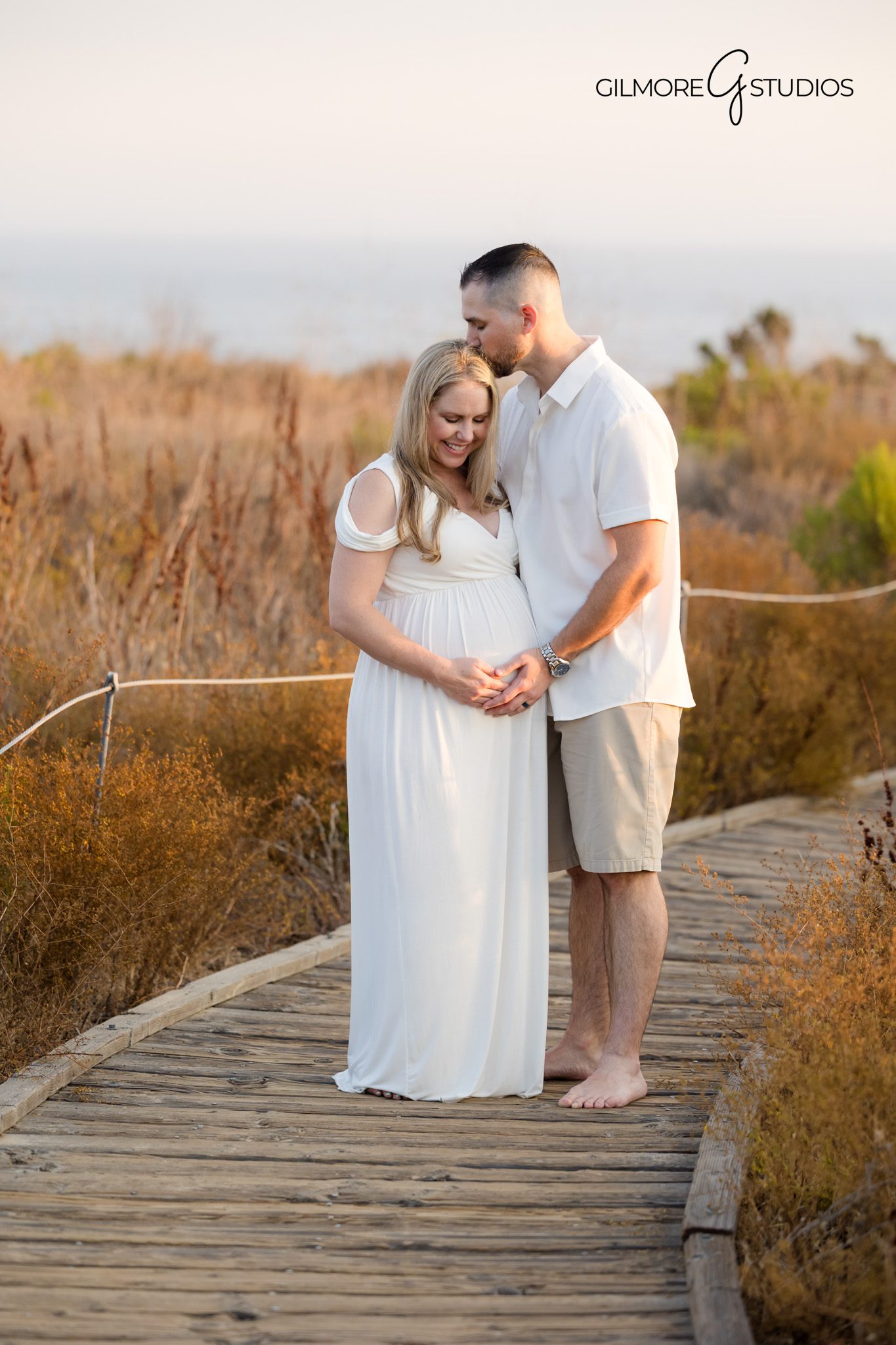 Crystal Cove maternity photography showing expecting parents sharing a laugh,

Maternity photographer capturing elegant beach pose in soft afternoon light