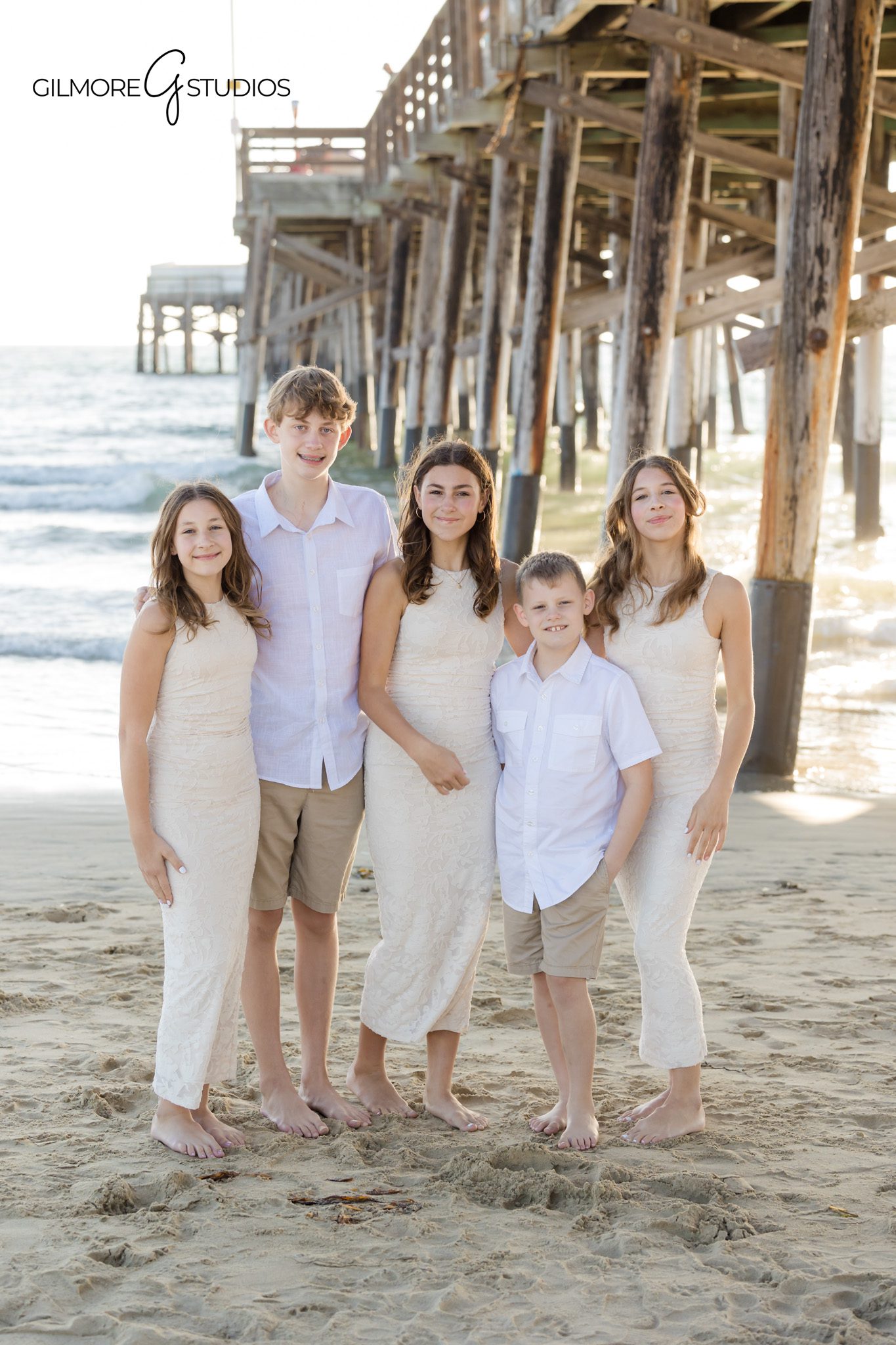 Grandparents and grandkids photographed together by Orange County photographer.

Family portrait showing siblings laughing at Newport Beach Pier.
