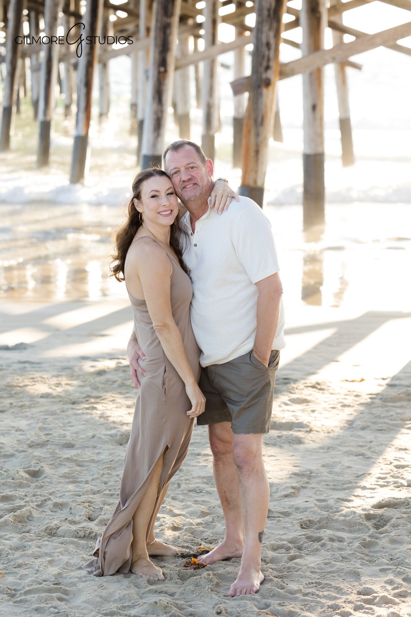 Newport Beach family photography with colorful sunset sky behind group.

Multigenerational portrait featuring grandparents at Newport Pier.