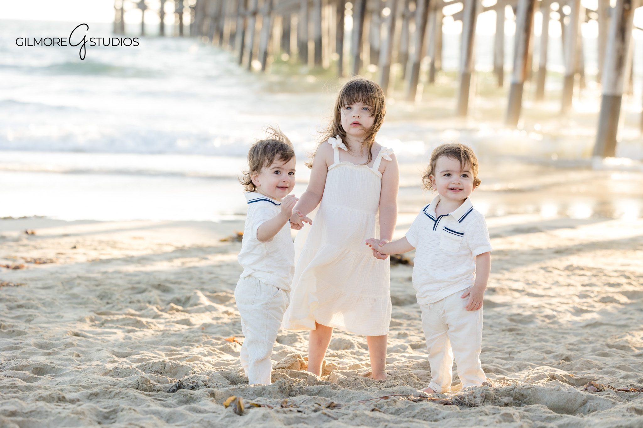 Orange County photographer capturing emotional family moments on the beach.

Photographer documenting cousins running near Newport Beach Pier.