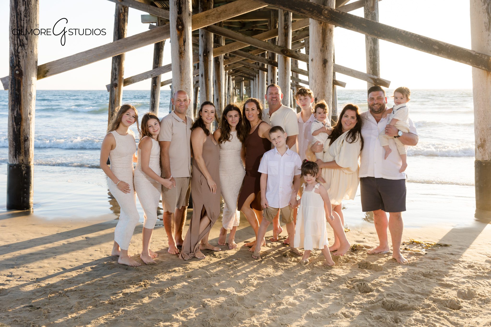 Orange County family photographer capturing beach silhouettes at Newport Pier.

Natural light portrait photography of extended family on coastal rocks.