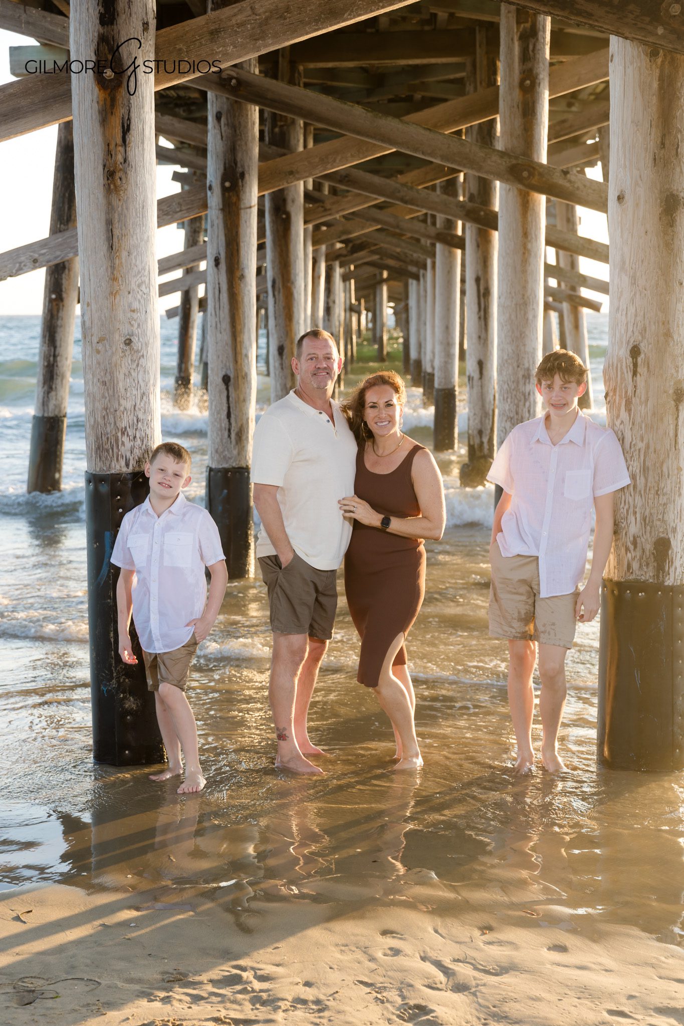 Newport Beach photographer capturing joyful extended family moment by the water.

Sunset portrait photography of multi-generation family at Newport Beach Pier.
