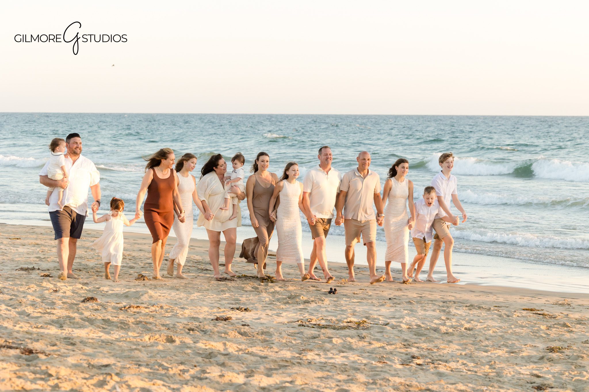 Professional portrait photographer photographing extended family on Newport Beach sand.

Candid family photography of grandparents and grandchildren at Newport Beach Pier.