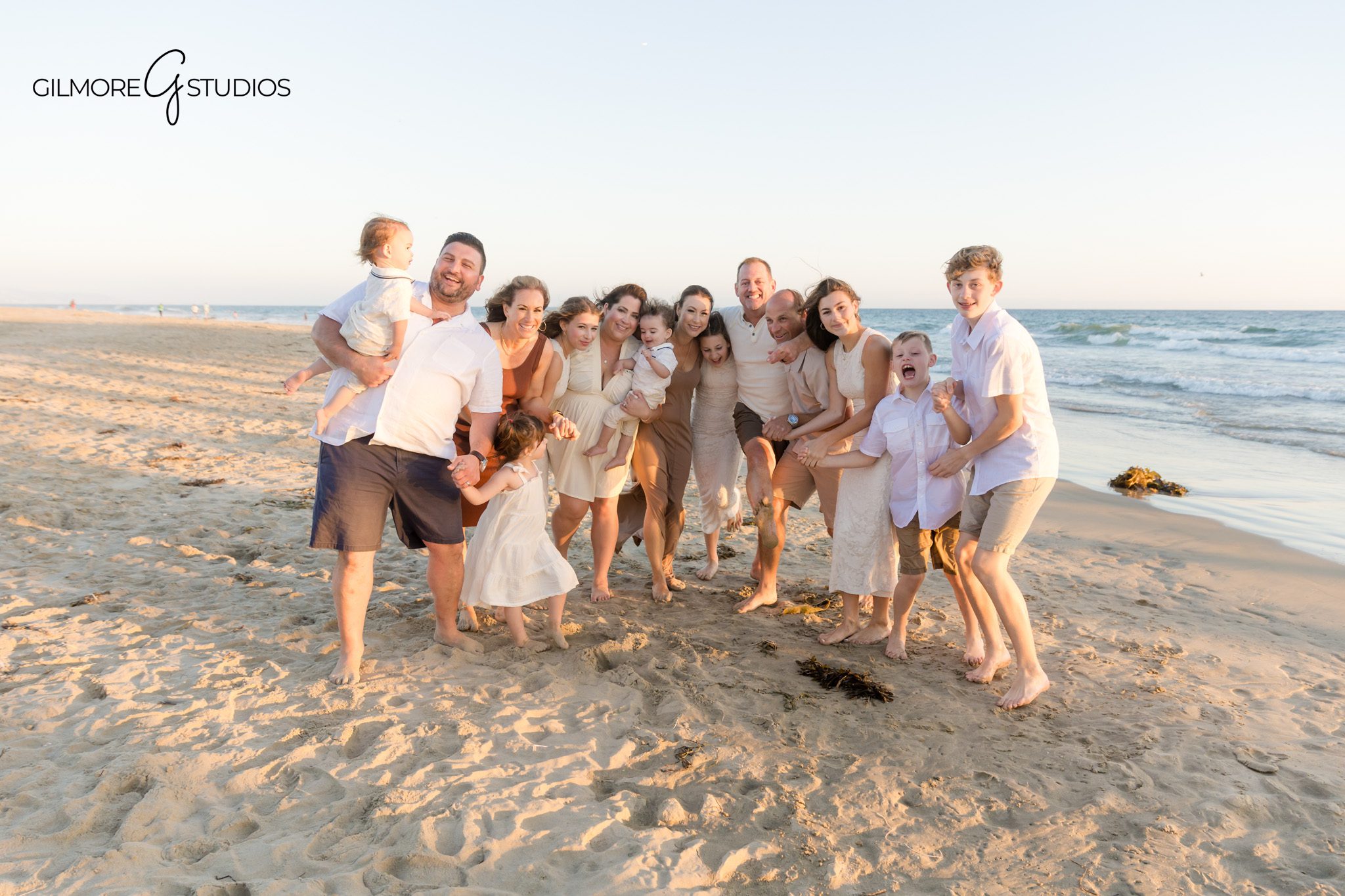 Newport Beach photographer capturing playful children during family session.

Orange County portrait photography of multiple generations in coordinated neutrals.
