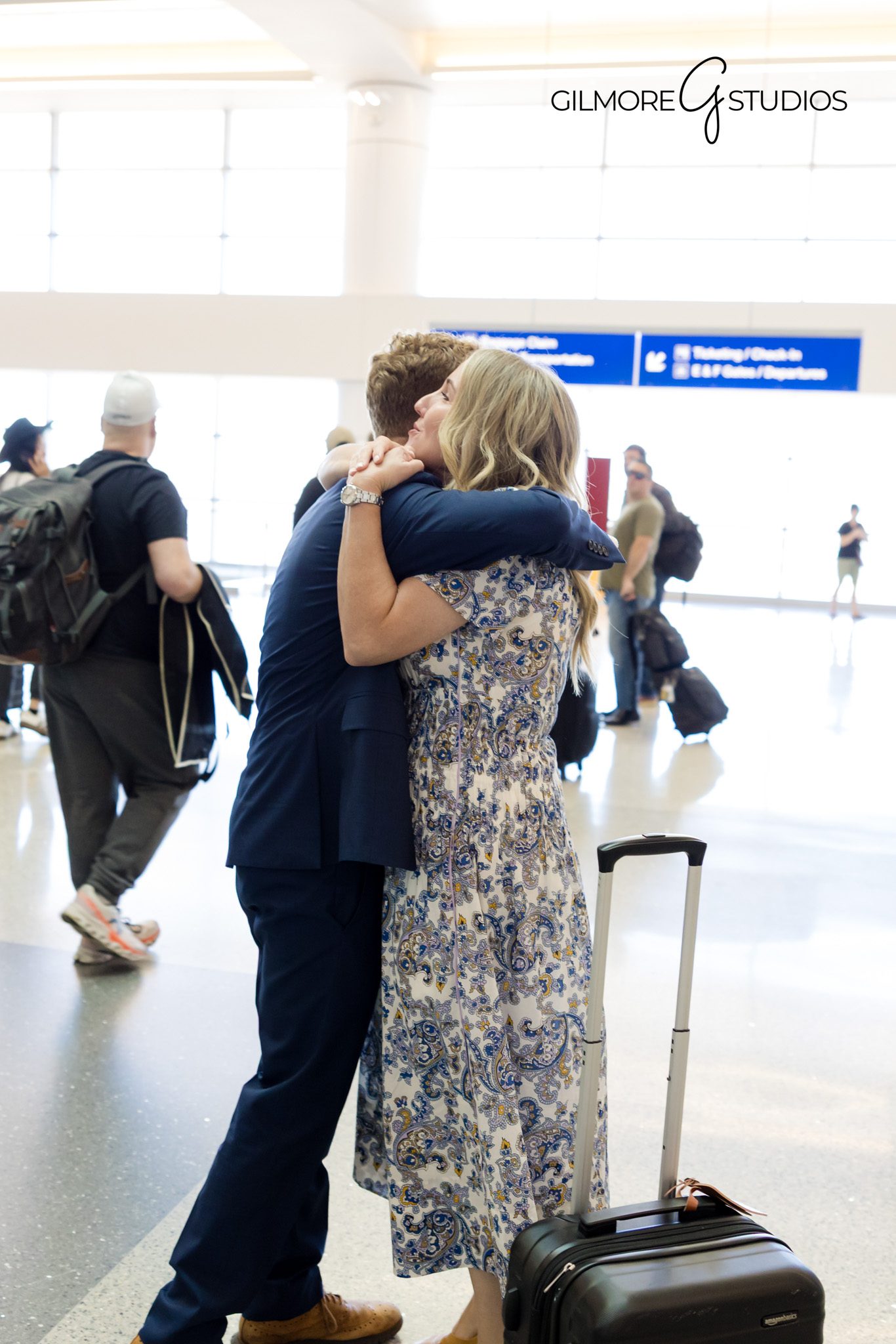 Phoenix airport LDS missionary welcome home photography by Gilmore Studios

Emotional family hug during Arizona LDS missionary homecoming at Phoenix Airport