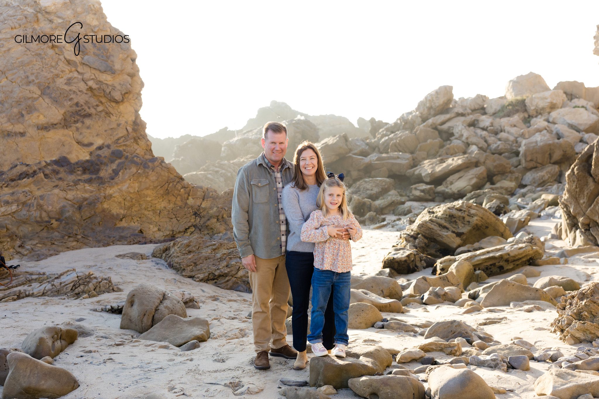 California coastal portrait photographer capturing glowing sunset at CdM.

CdM photographer capturing playful family moment splashing in shallow water.