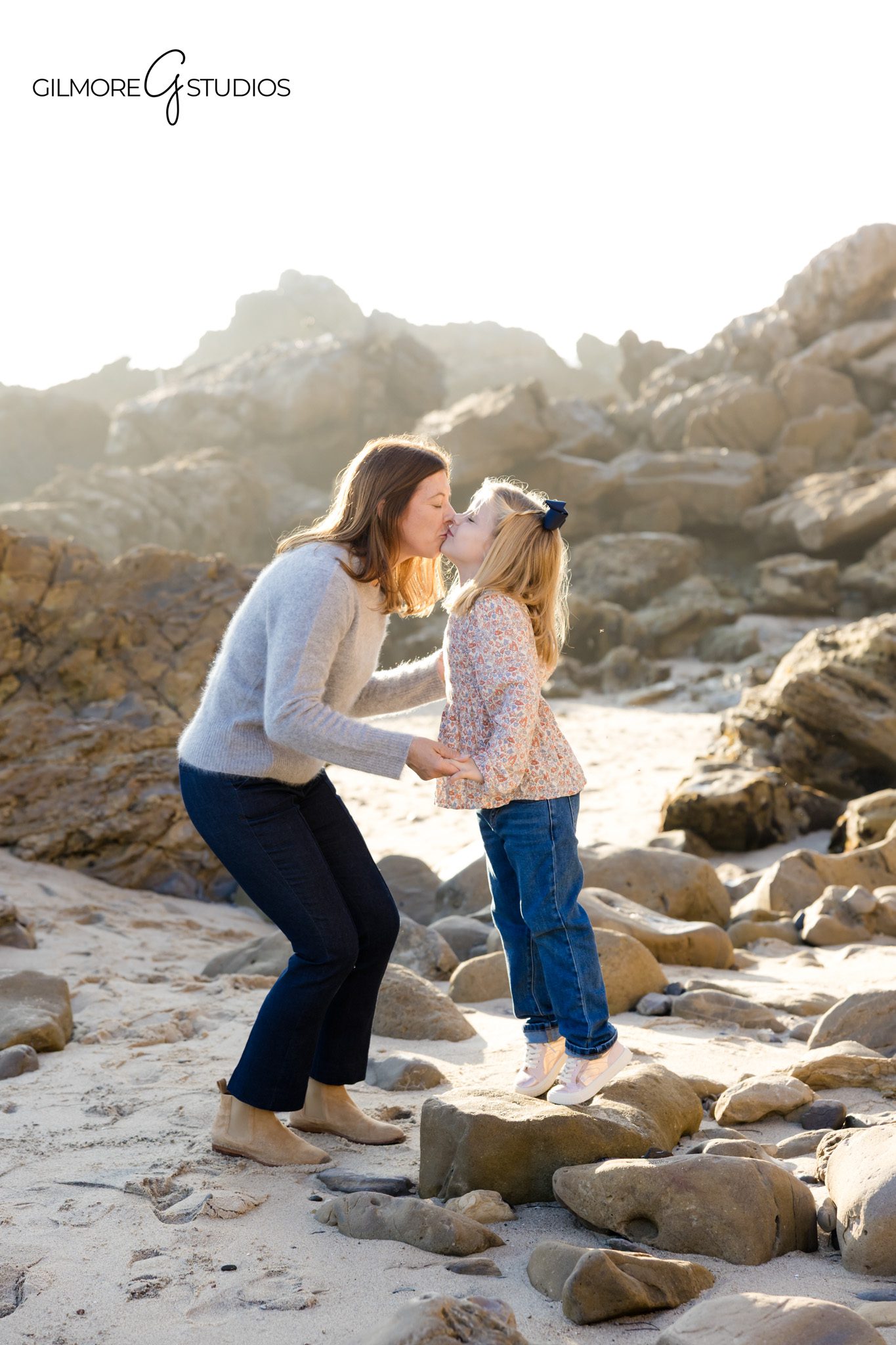 Family portrait photography during golden hour at Corona del Mar cliffs.

Candid beach photography capturing siblings running along CdM waves.