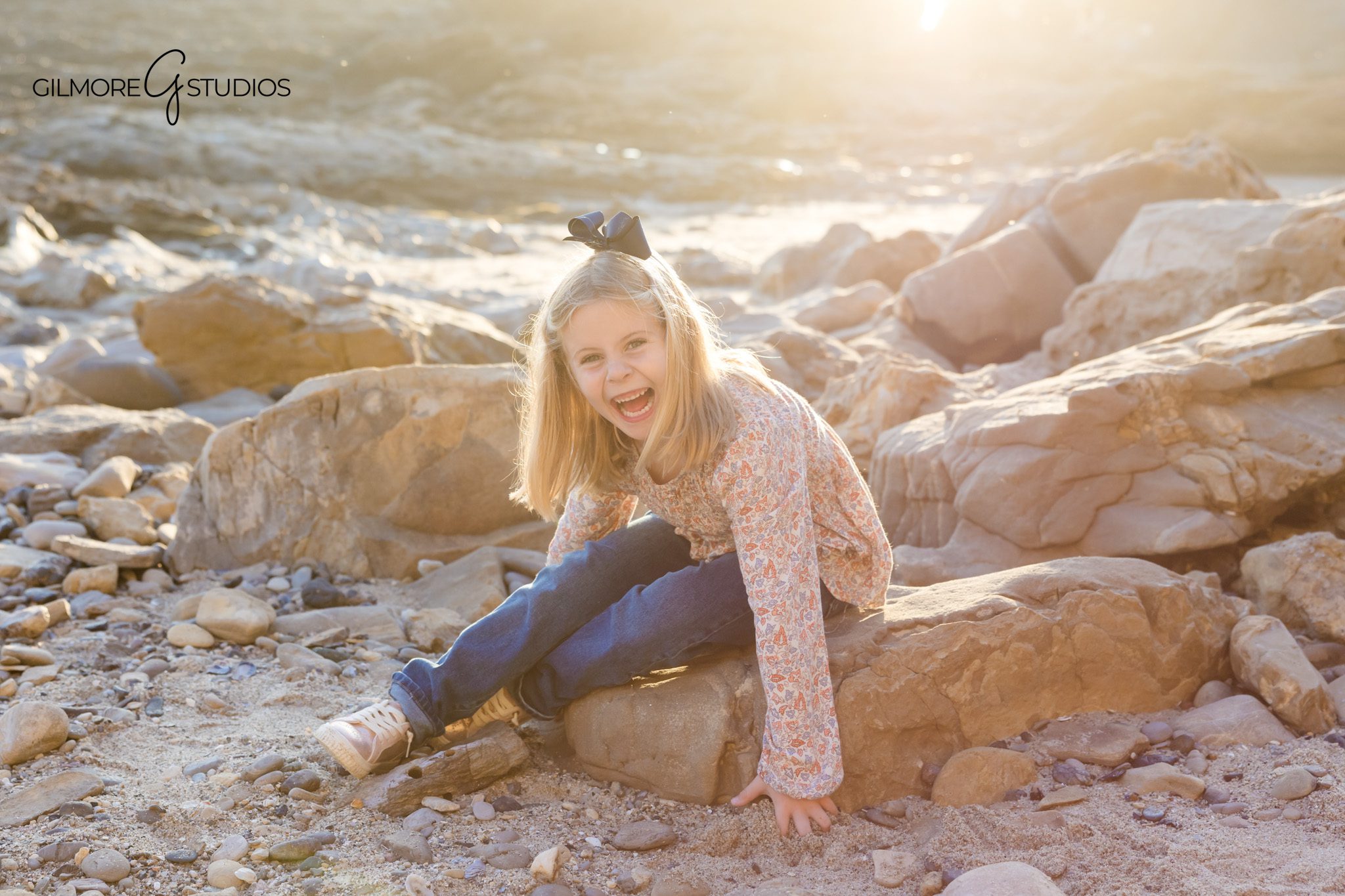 Soft and timeless family portraits photographed at Corona del Mar by Gilmore Studios.

Orange County beach photography capturing relaxed family interactions.