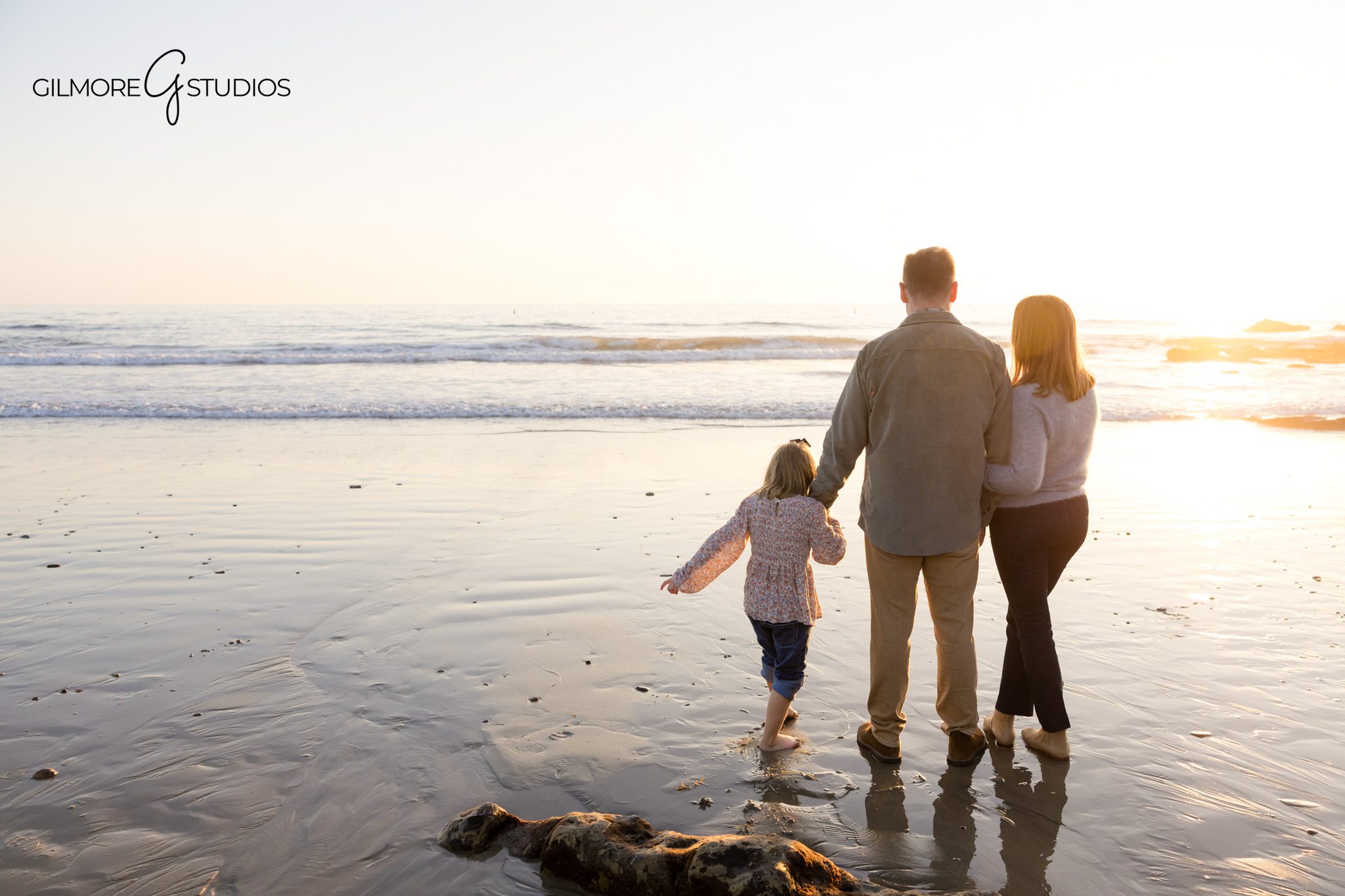 Orange County beach family session with warm natural light and ocean breeze.

Professional photographer capturing family snuggling on CdM rocks at sunset.