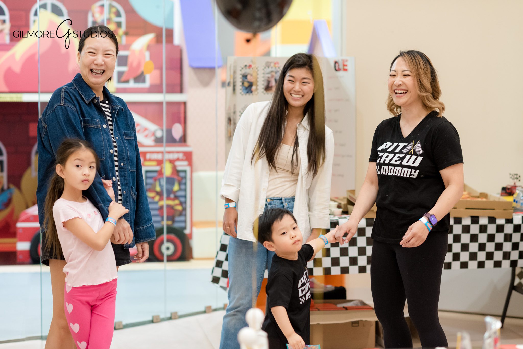 Portrait photographer capturing birthday child’s reaction to opening gifts.

Gilmore Studios photographer documenting family moments at PlayPie Buena Park.