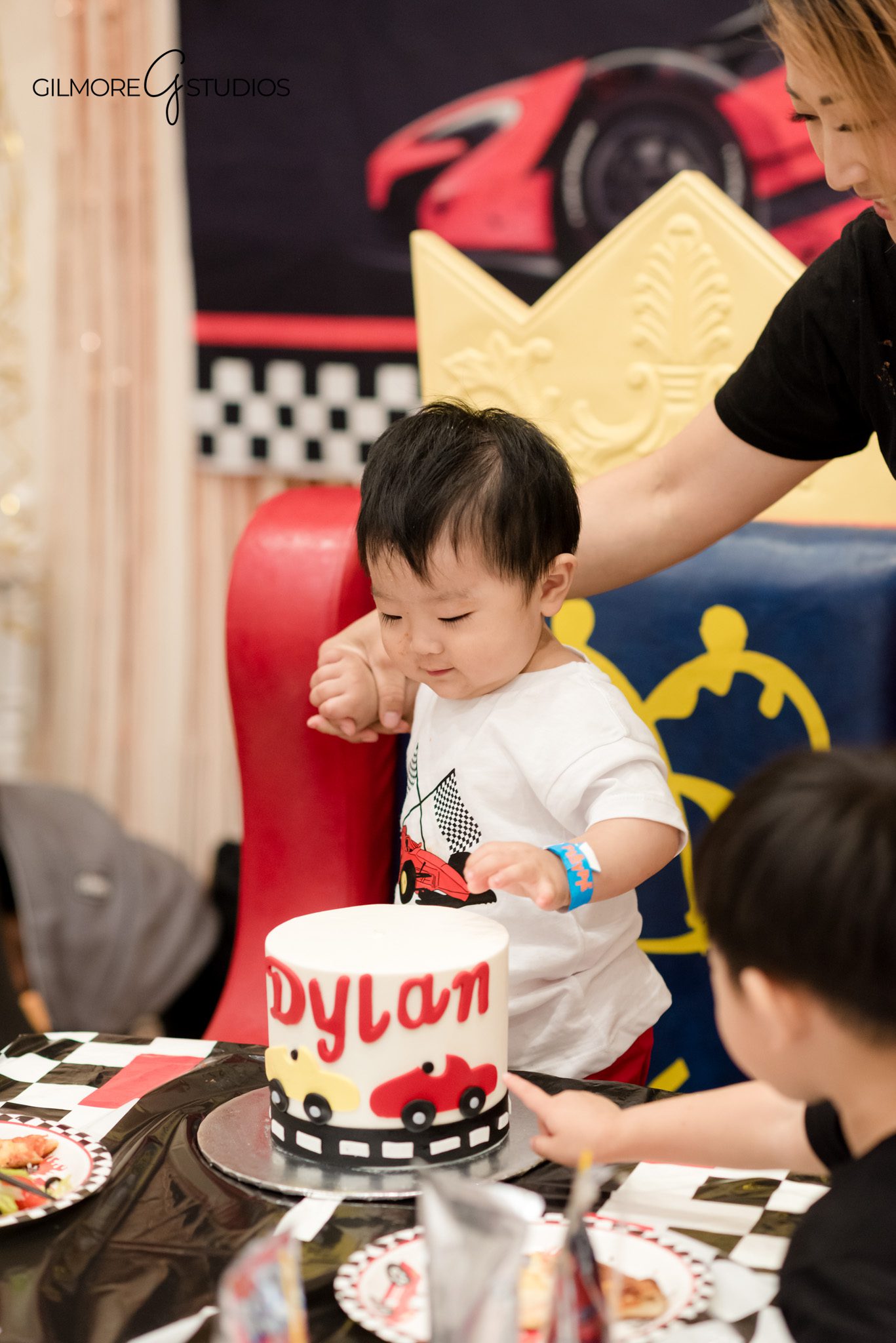 Birthday event photography showing happy group of children posing together.

PlayPie indoor birthday photographer capturing child with balloons and cake.
