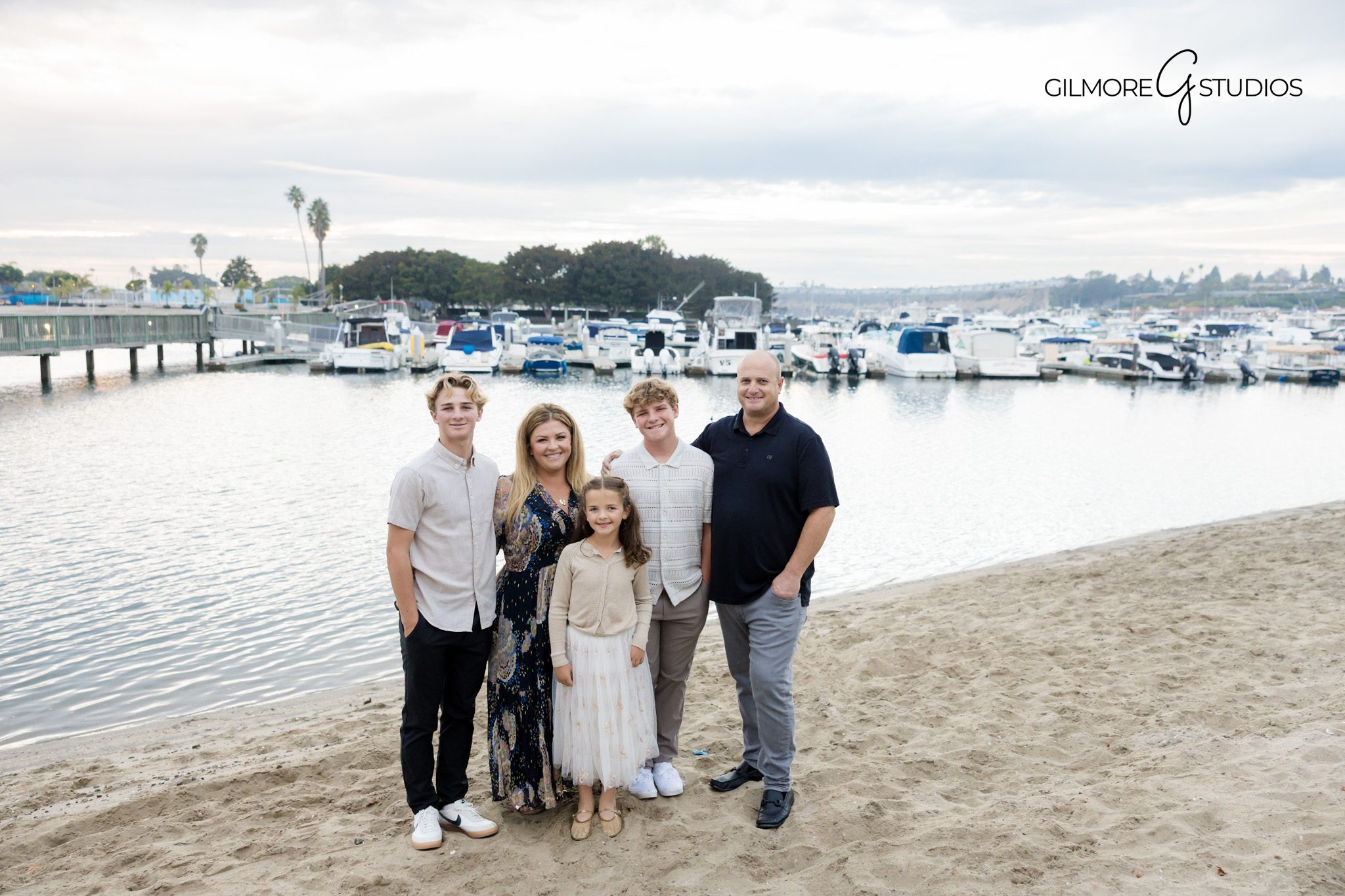 Los Angeles portrait photographer capturing siblings laughing together.

Malibu beach family photography showing warm light and soft waves.