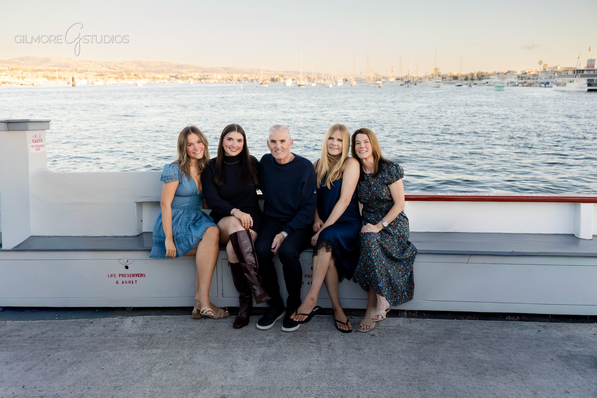 Family portrait photographer documenting festive moments on Balboa Island,

Balboa Island holiday photography capturing family walking by boats,