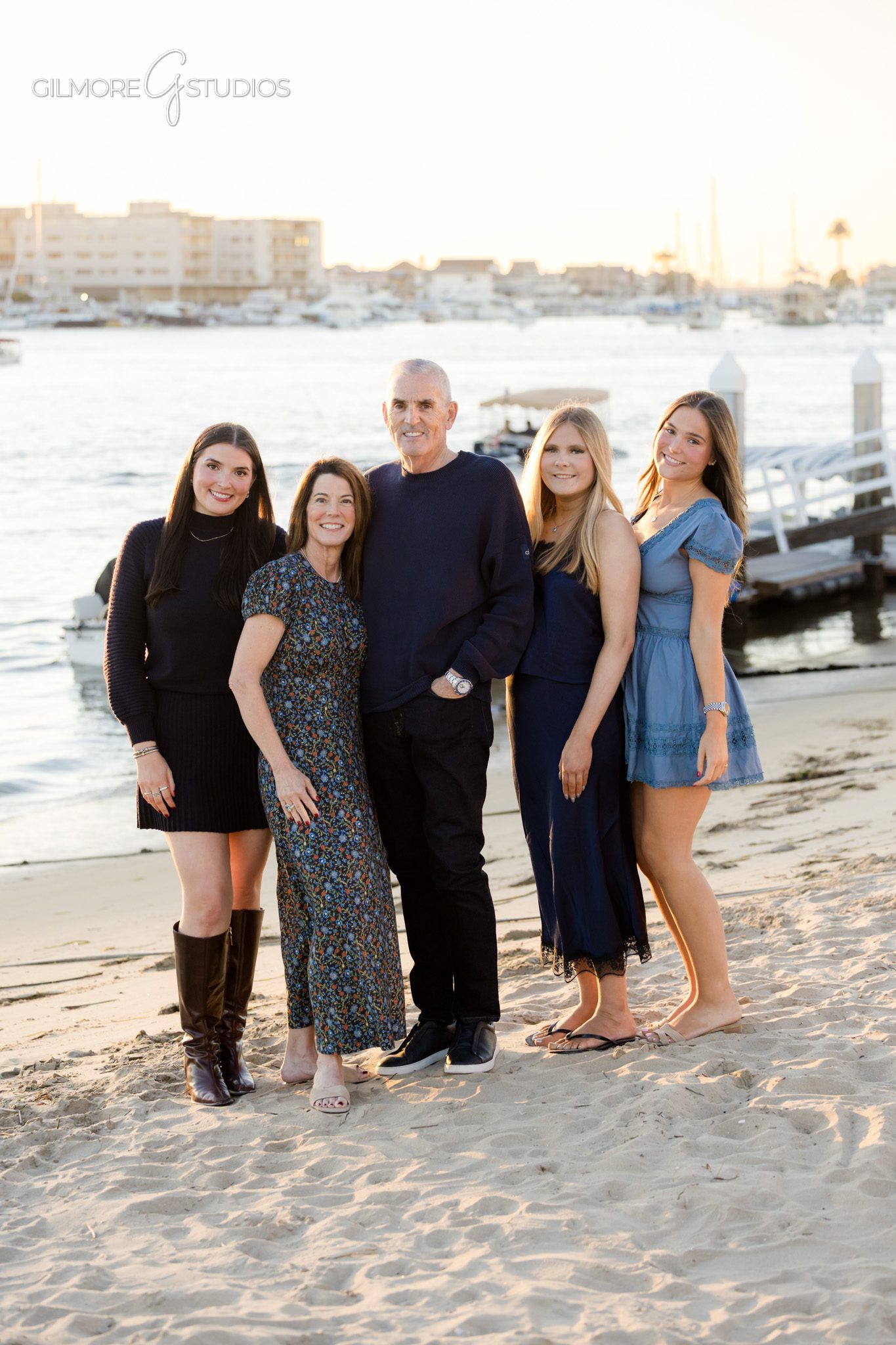 Balboa Island Christmas portraits with professional family photographer,

Holiday photography showing family cuddling on Balboa Island docks,