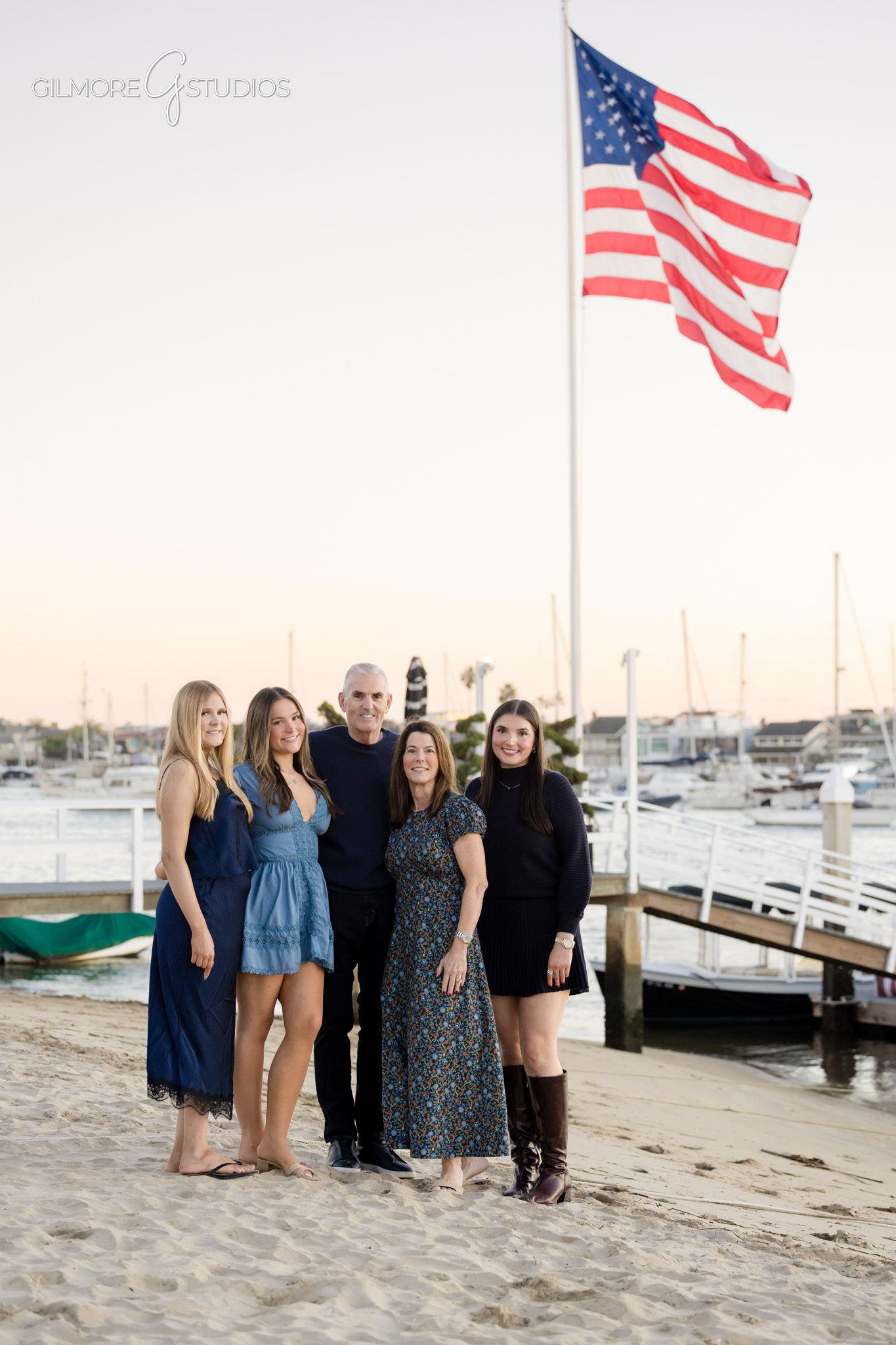 Balboa Island family portraits with festive color palette,

Holiday family photography on Balboa Island with sailboats behind them