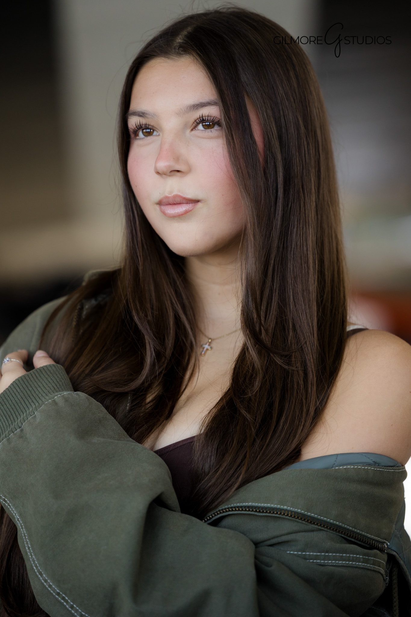 Senior girl posing naturally with aircraft exhibit in background
Polished senior portrait with Orange County photographer at museum