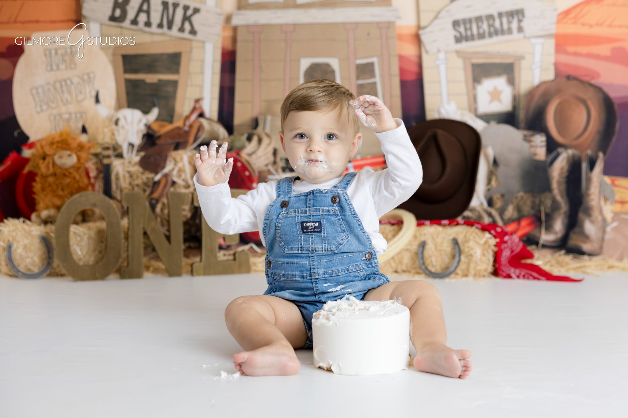 Baby boy cowboy cake smash photography in Scottsdale studio,

First birthday portrait photographer using western decorations and cake