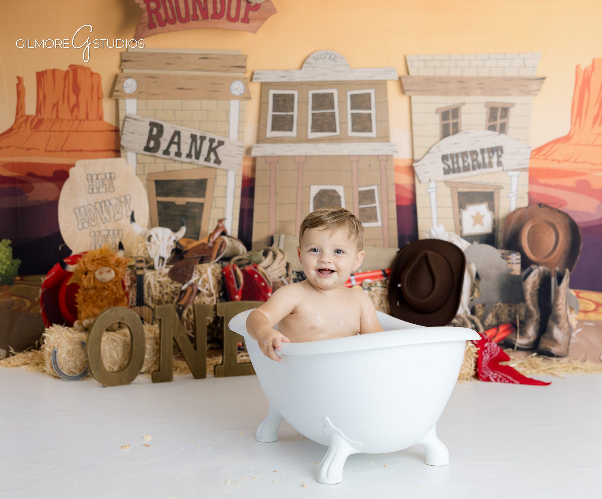 Western roundup cake smash photographed by Scottsdale baby photographer,

First rodeo portrait session with cowboy boots and rope details