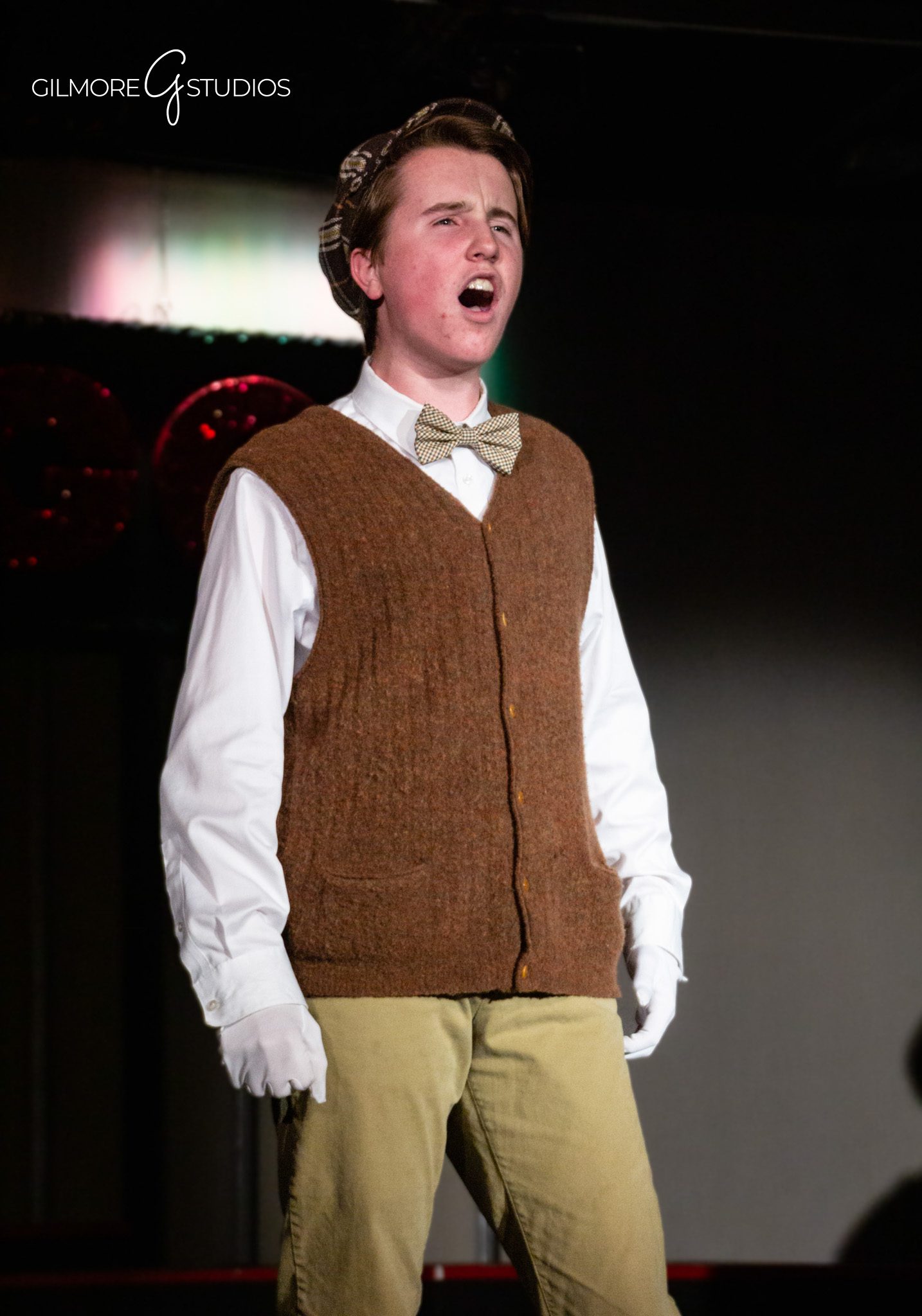 Professional commercial photographer capturing dress rehearsal for marketing use.
Stage photographer documenting full cast during final curtain call performance.