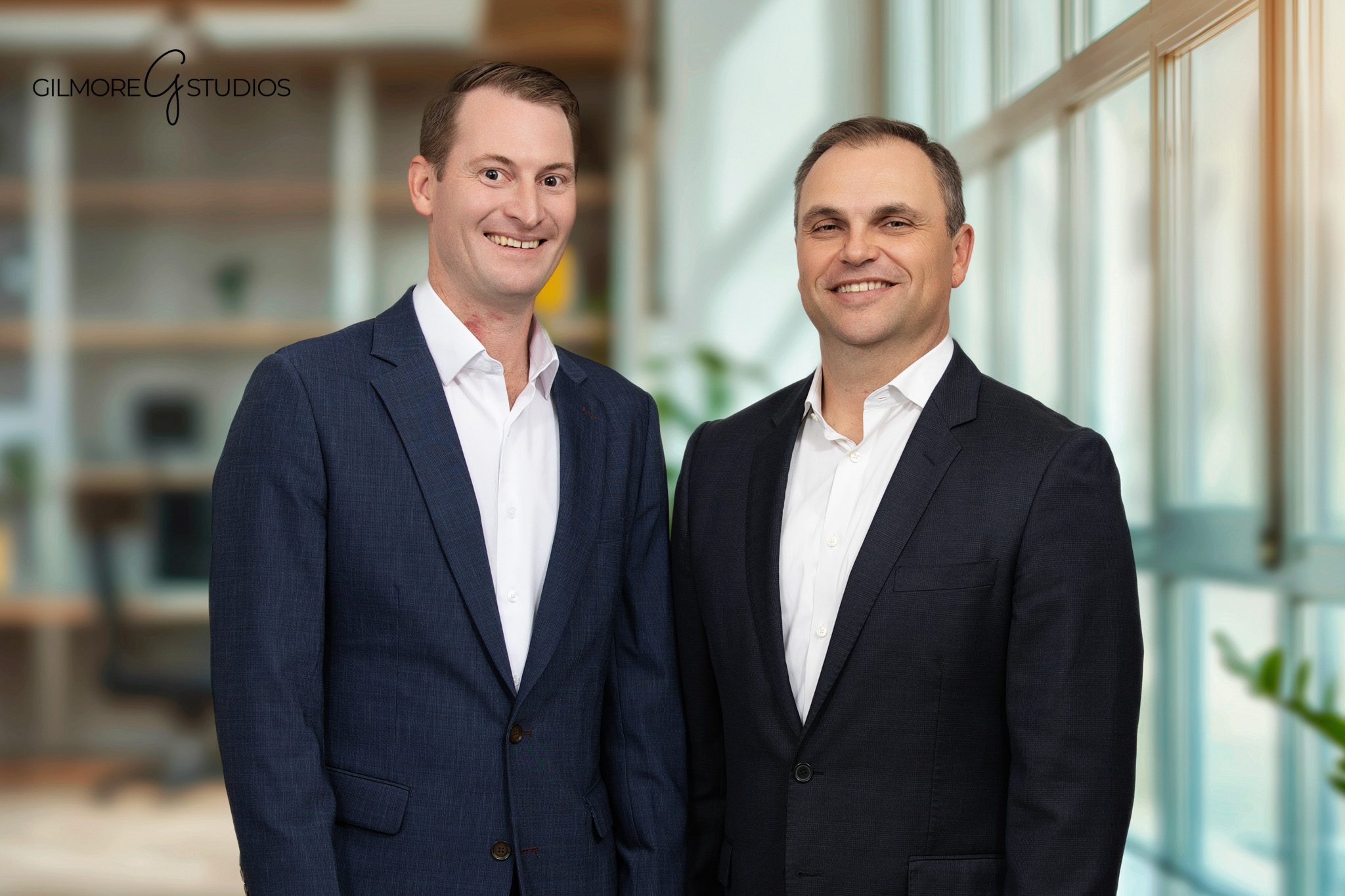 Corporate event photographer documenting team introduction on stage.
Event photography capturing candid hallway networking moments.