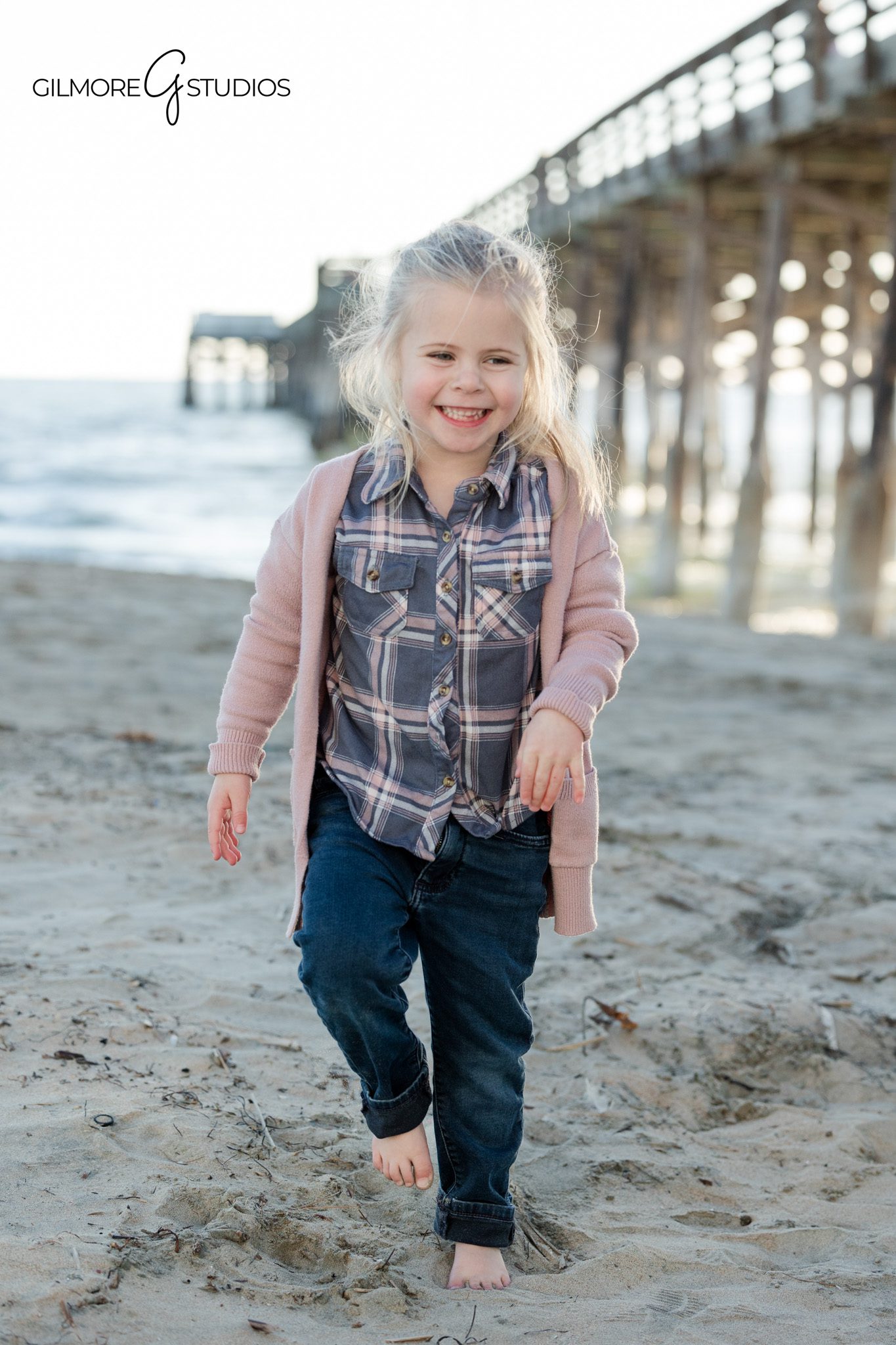 Family portrait photography featuring a young daughter walking near Newport Pier
Pier family photography at Newport Beach with natural interaction and connection
