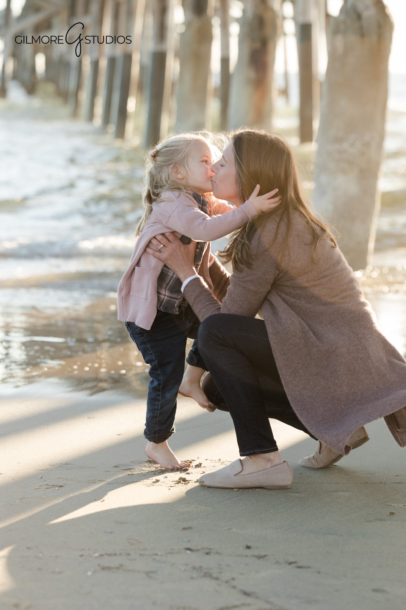 Pier family portrait photography with a young daughter at Newport Beach California
Newport Beach family photography session featuring parents and young child at the pier