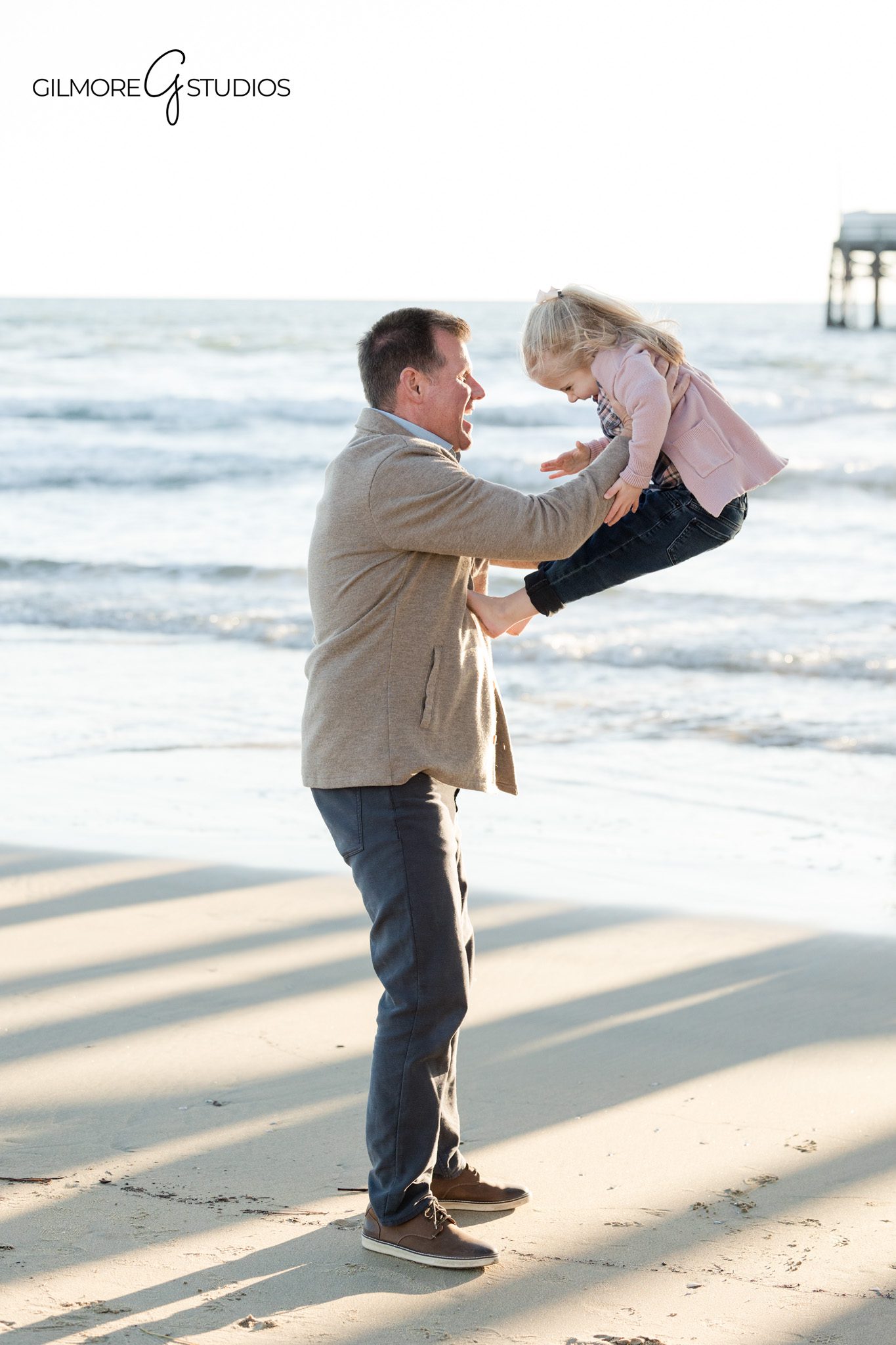 Family photography session at Newport Pier with a young child and coastal scenery
Newport Beach family photographer capturing pier family photos with a young daughter