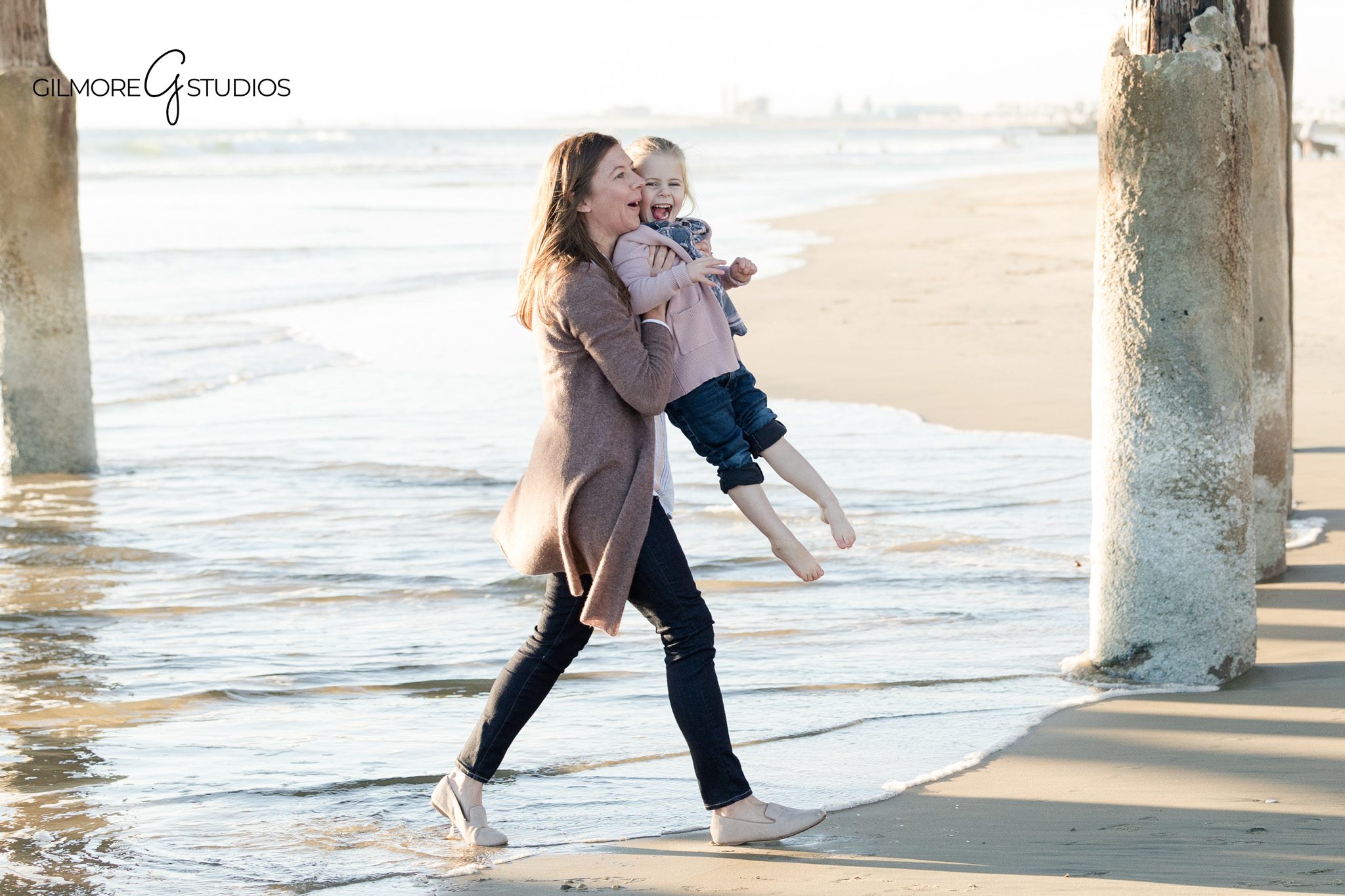 Beach family photography session at Newport Pier with parents and young child
Newport Beach family photographer documenting a relaxed pier family session