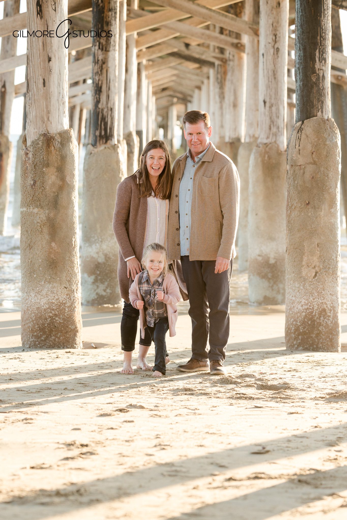 Family portrait photography at Newport Beach with a young daughter by the pier
Newport Beach pier family photos photographed with soft coastal light